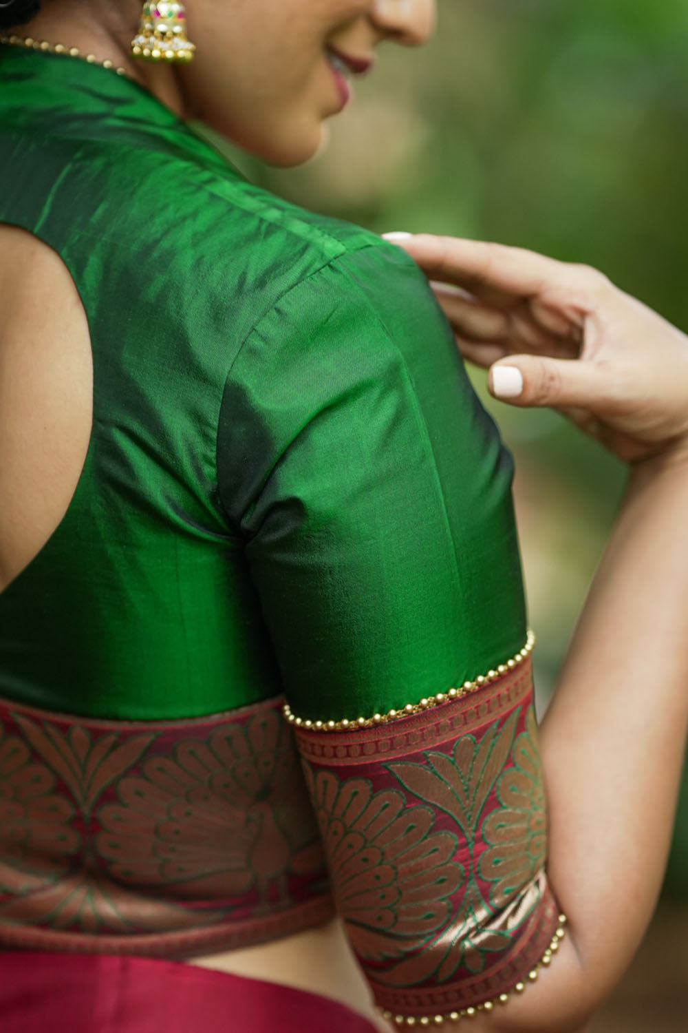 Emerald green silk pot neck blouse with peacock brocade border