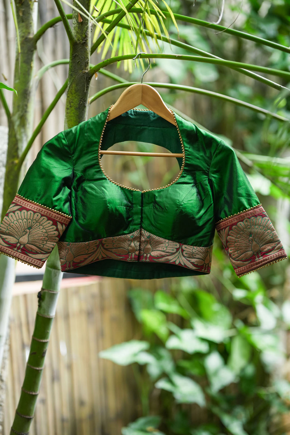 Emerald green silk pot neck blouse with peacock brocade border