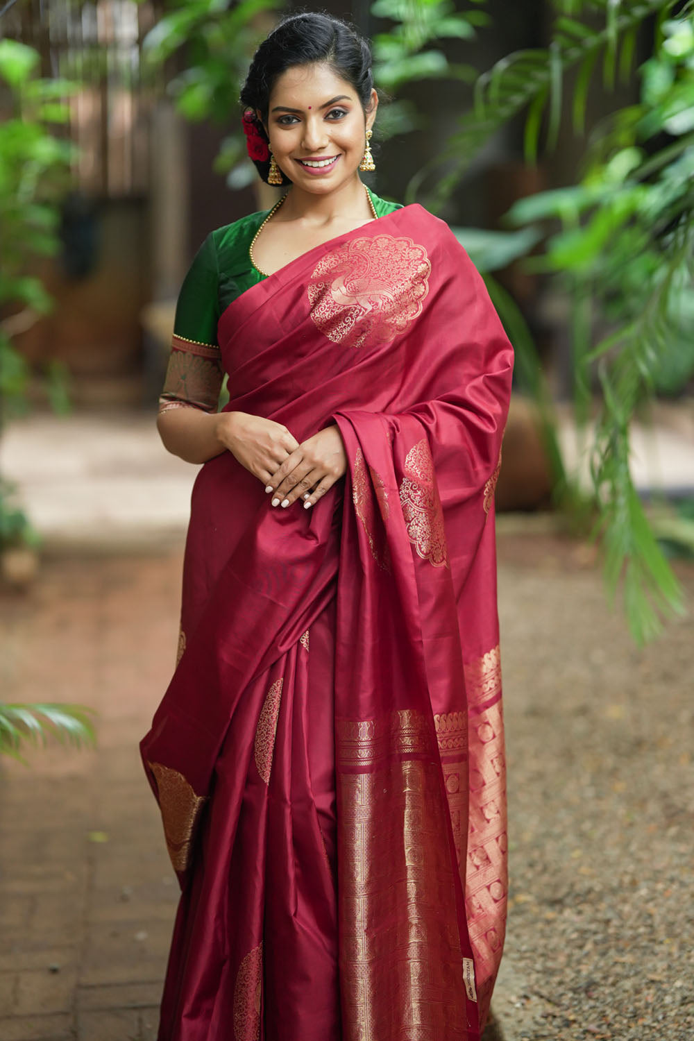 Deep red Kanjivaram saree with dacing peacock motifs