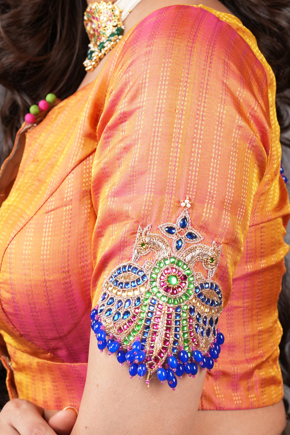 Kesari pure kanjivaram silk close neck blouse with handworked motifs on back and sleeves.