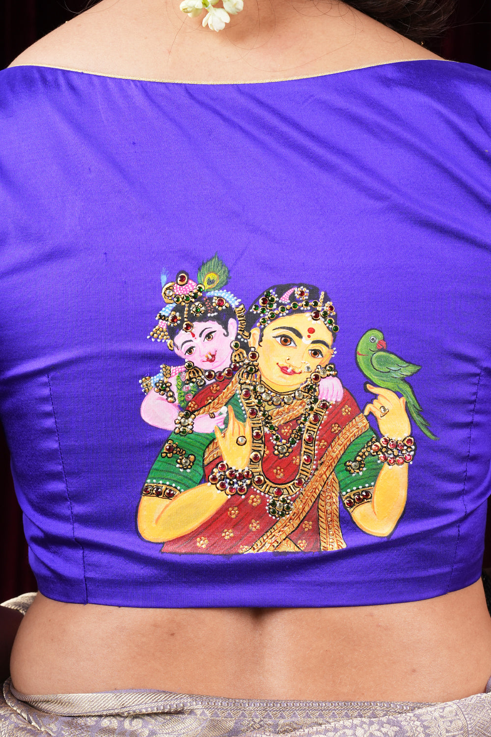 Purple pure silk sweetheart neck blouse with handpainted and hand embroidered baby Krishna and Yashodha and detailing on sleeves.