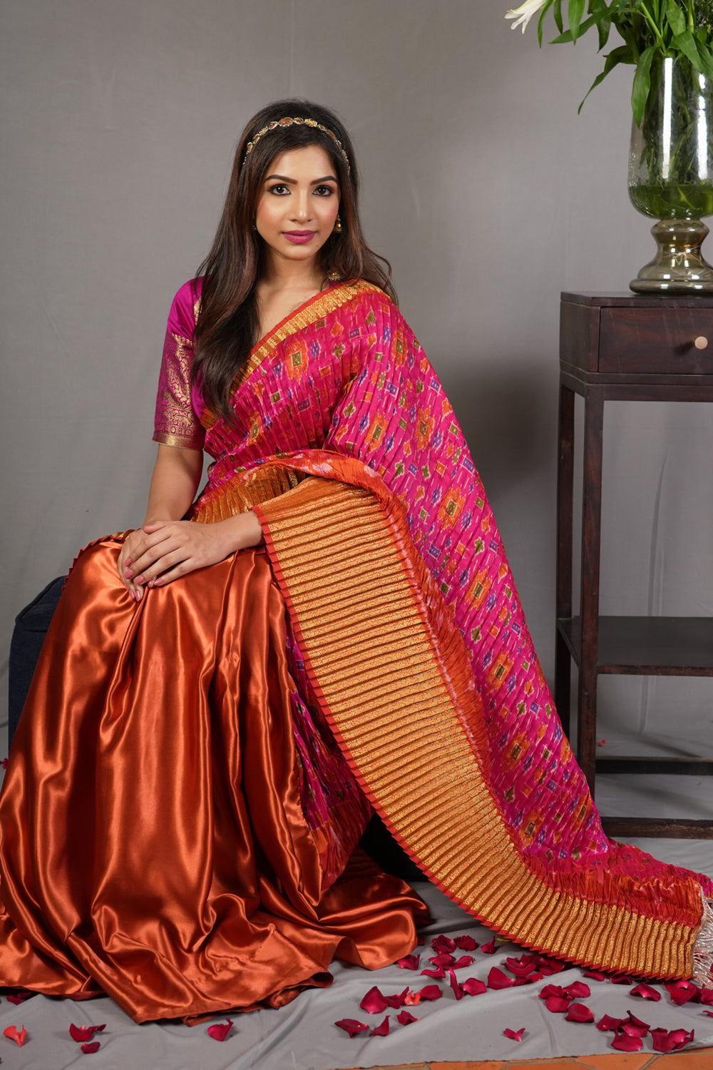 Pink and rust pleated half and half satin saree with patola digital print.