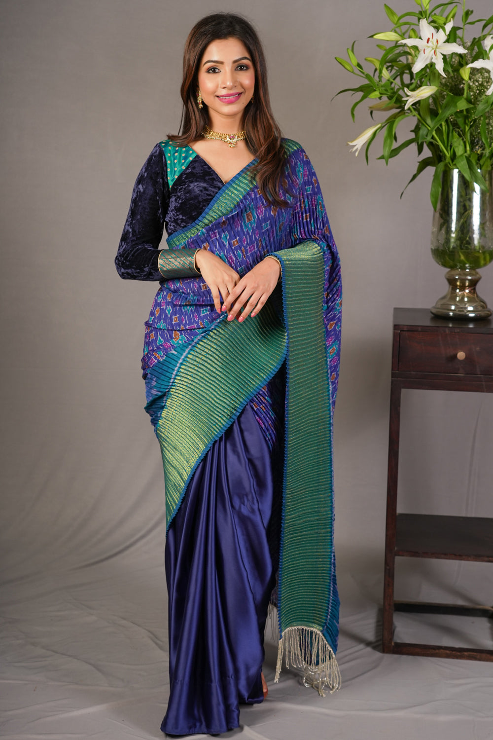 Royal blue and green pleated half and half satin saree with patola digital print.