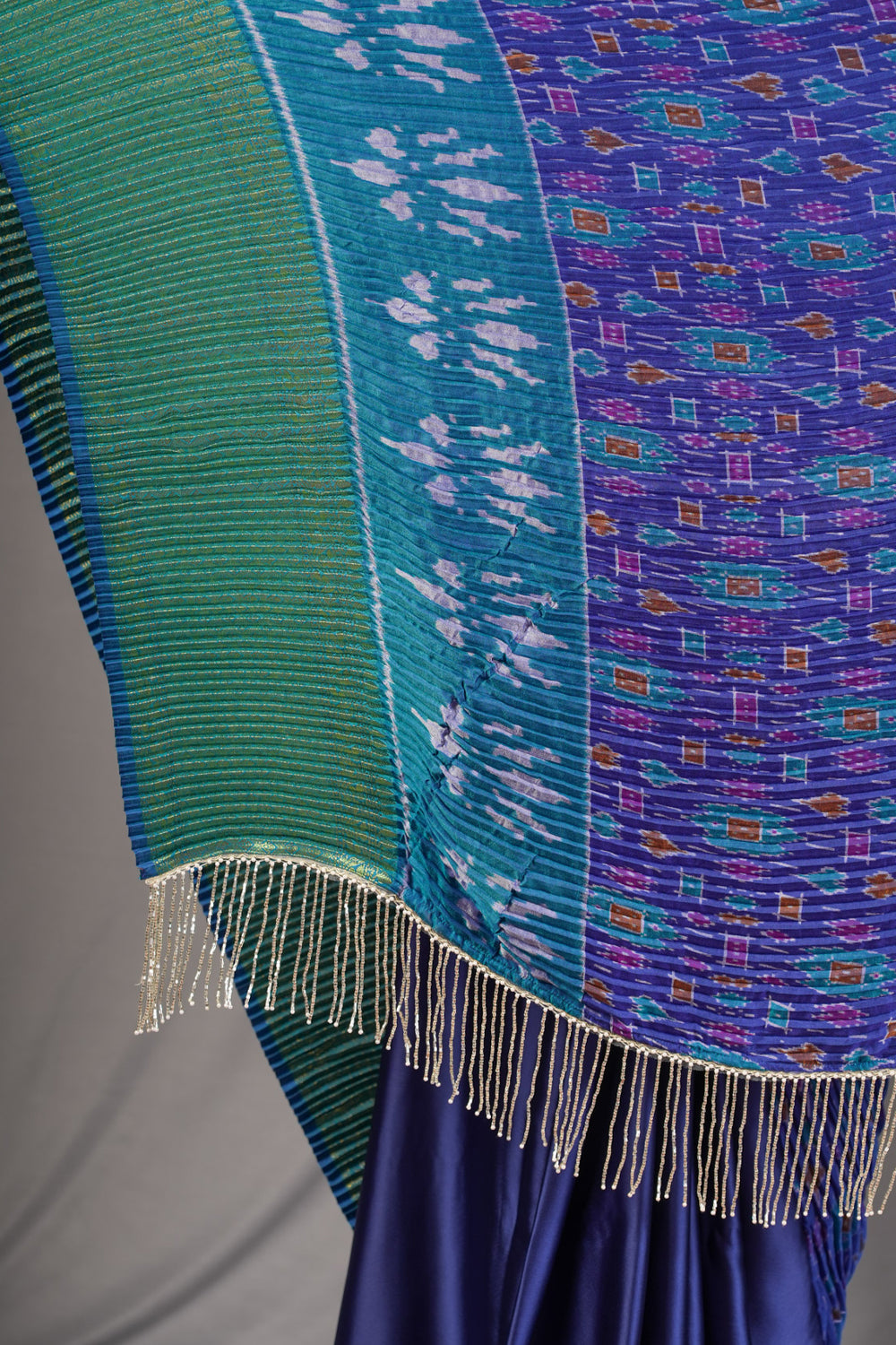 Royal blue and green pleated half and half satin saree with patola digital print.