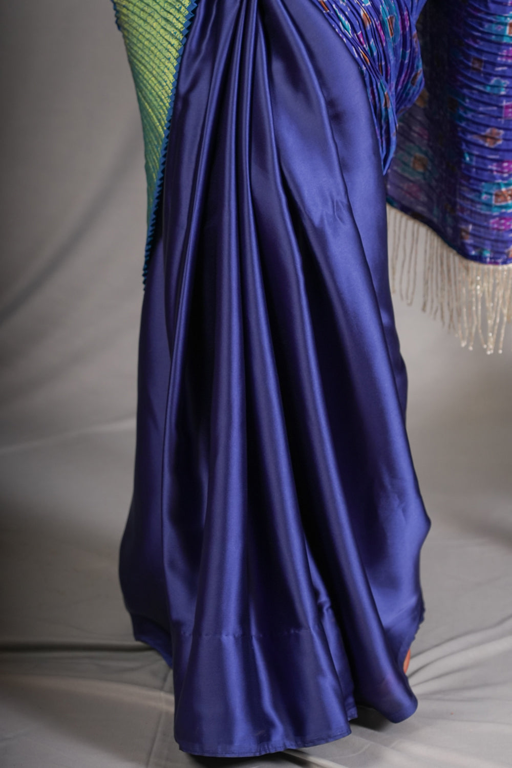 Royal blue and green pleated half and half satin saree with patola digital print.