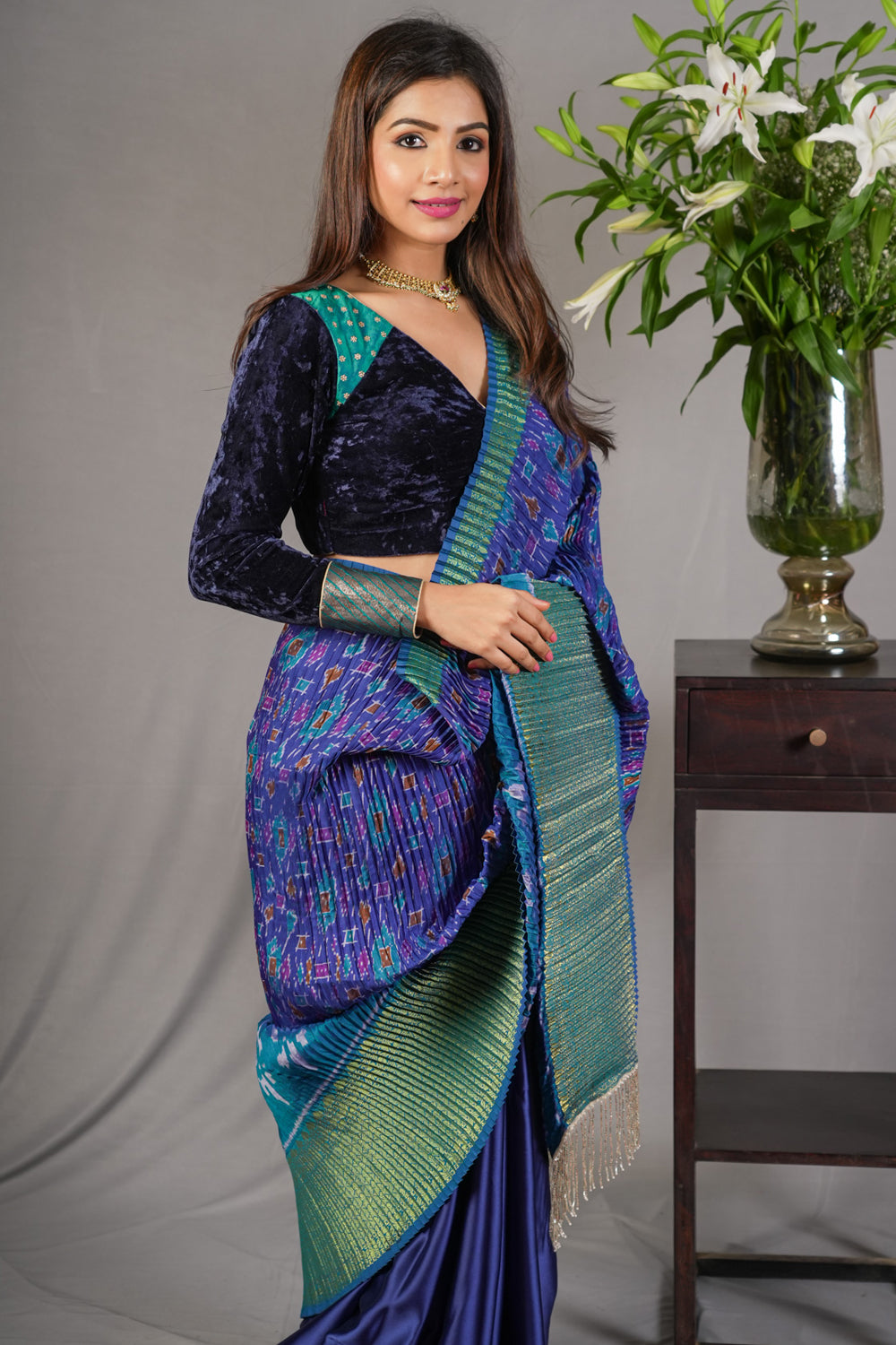 Royal blue and green pleated half and half satin saree with patola digital print.