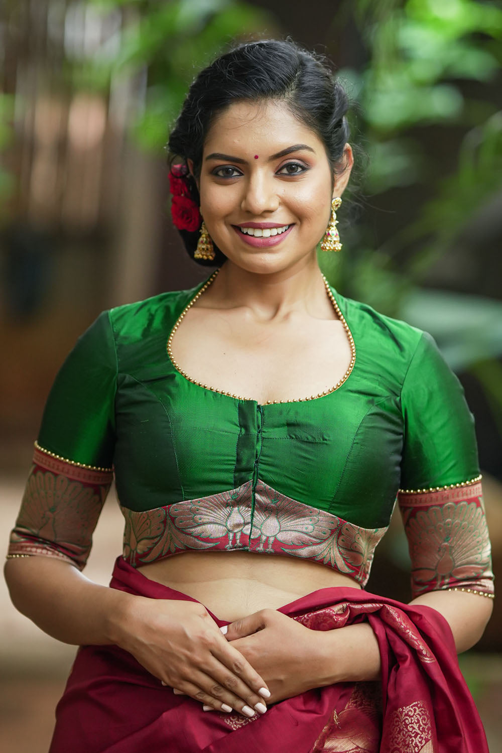 Emerald green silk pot neck blouse with peacock brocade border