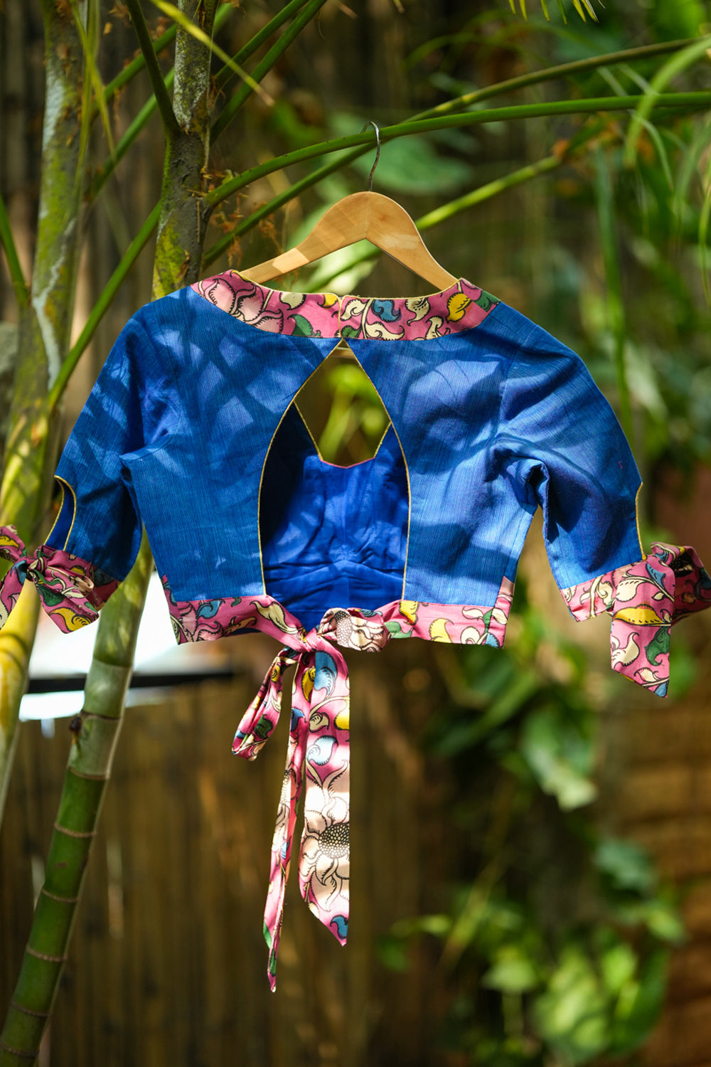 Ocean blue handloom V neck blouse with rose pink handpainted kalamkari border detailing.