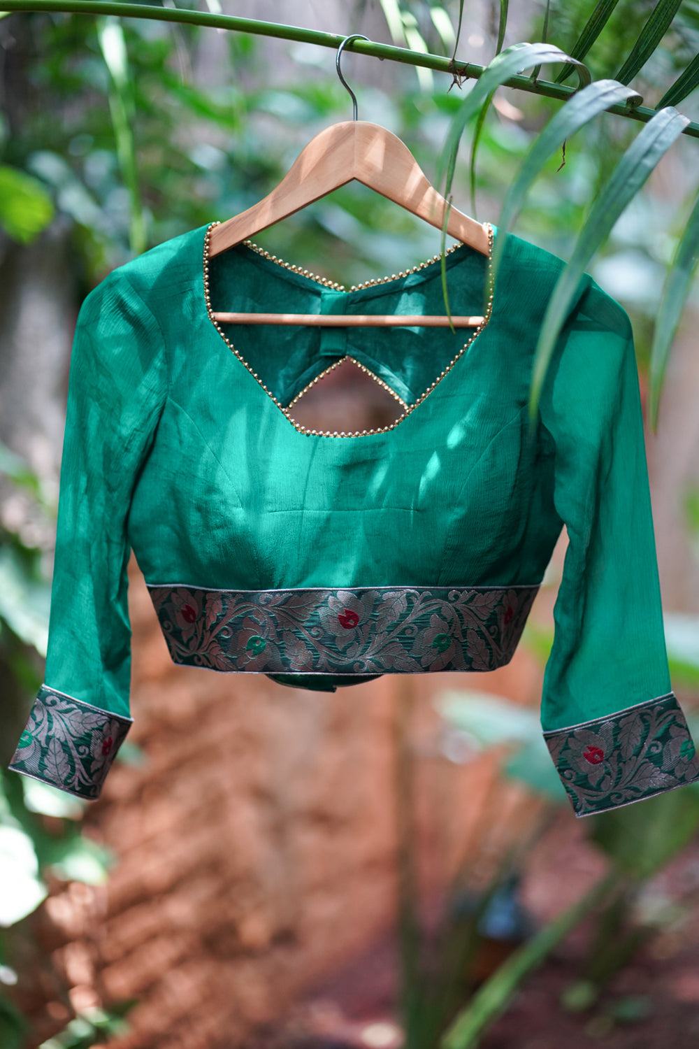 Green chiffon blouse with brocade detailing and sheer sleeves
