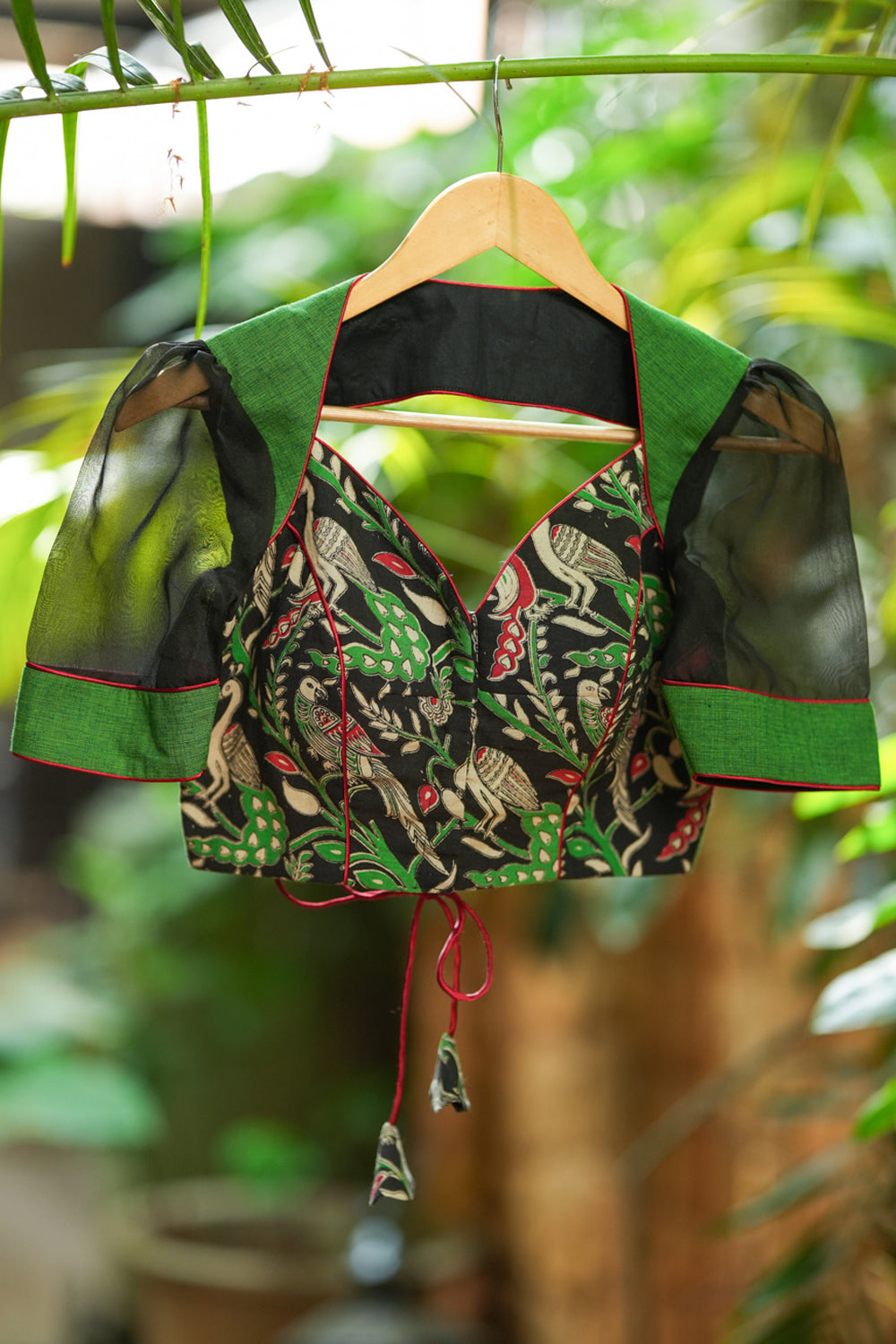 Forest green and black handpainted kalamkari sweetheart neck blouse with black Organzasleeves.