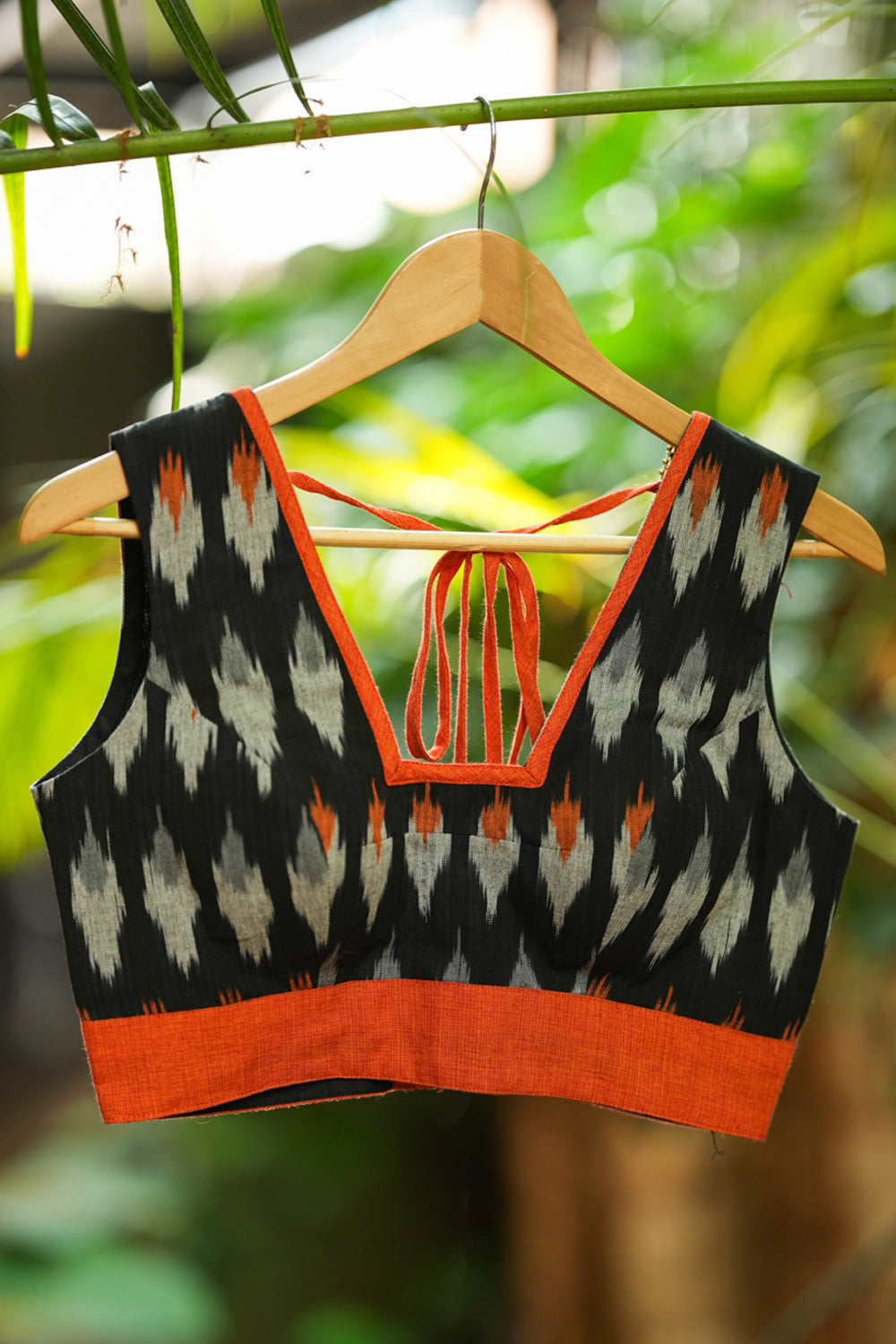 Black and orange cotton ikat square neck sleeveless blouse with orange handloom border.