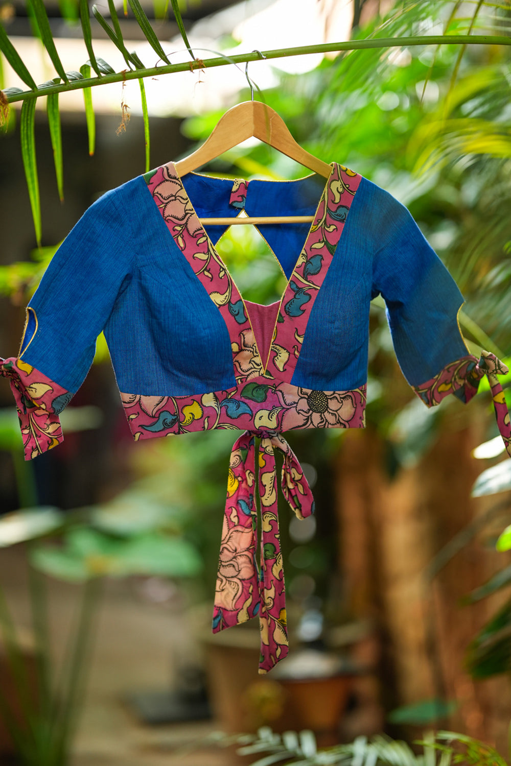 Ocean blue handloom V neck blouse with rose pink handpainted kalamkari border detailing.