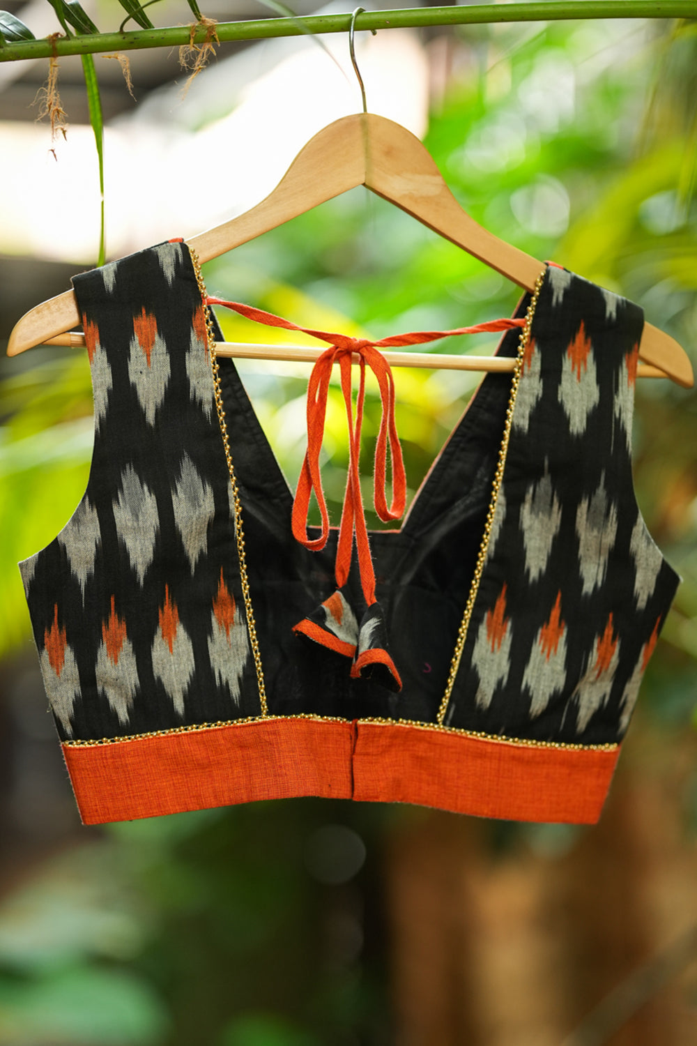 Black and orange cotton ikat square neck sleeveless blouse with orange handloom border.