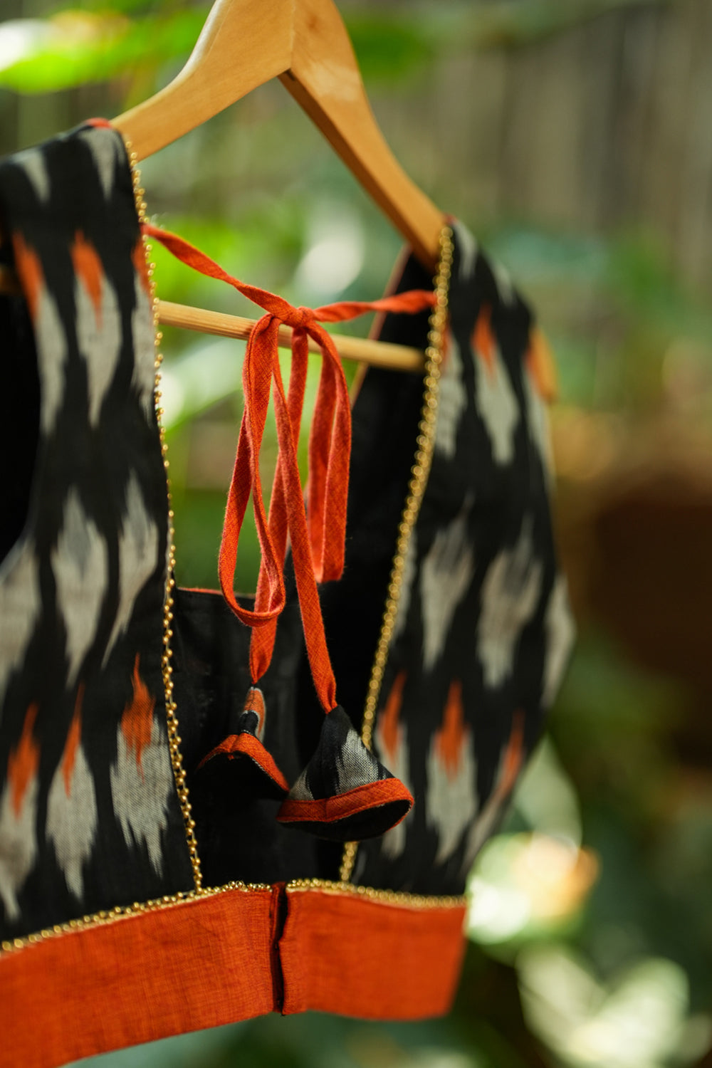 Black and orange cotton ikat square neck sleeveless blouse with orange handloom border.