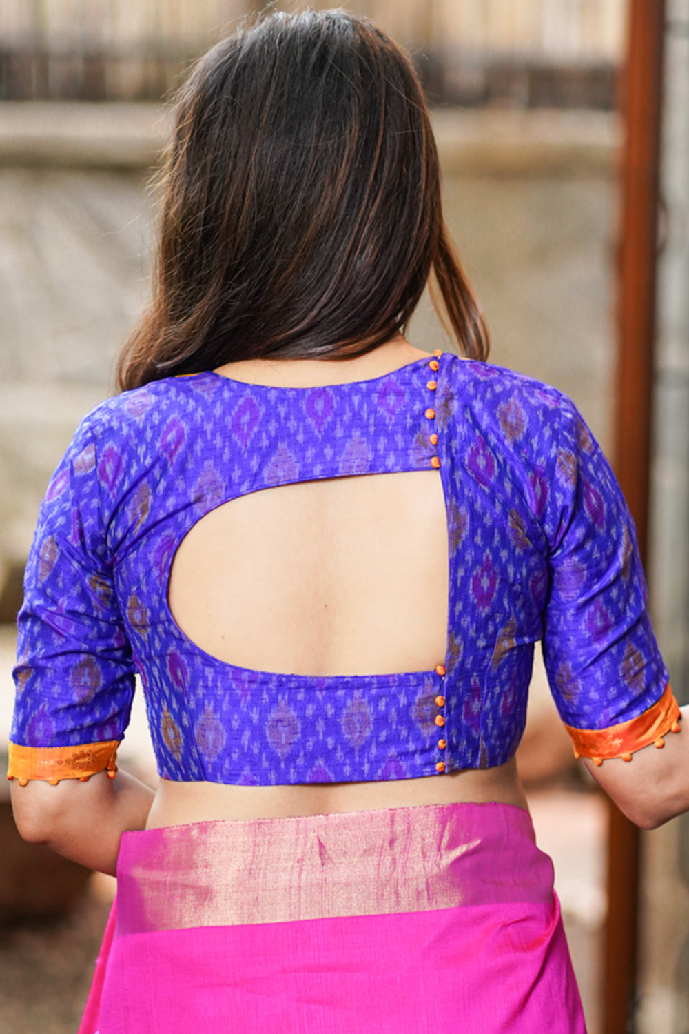 Pure handwoven ikkat on raw silk and kanjivaram silk brocade yoke on back cutout blouse with potli buttons