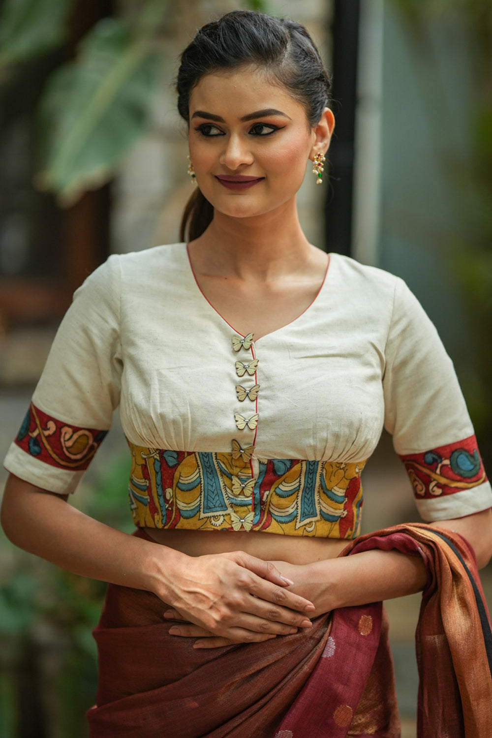 Daisy white V neck blouse with handpainted kalamkari border.