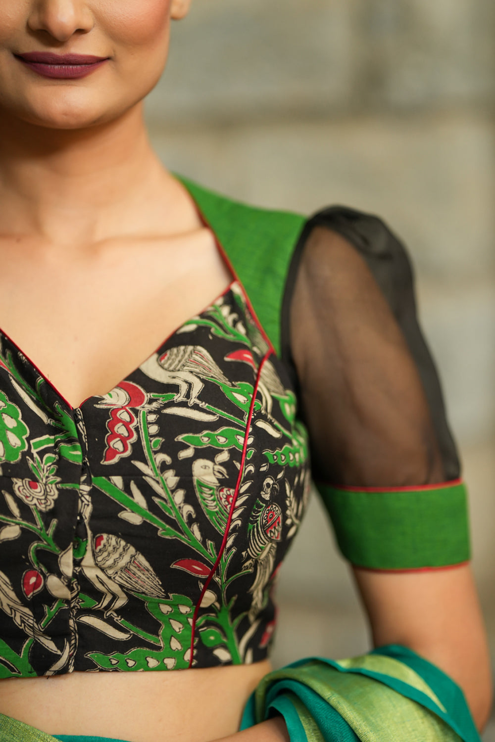 Forest green and black handpainted kalamkari sweetheart neck blouse with black Organzasleeves.