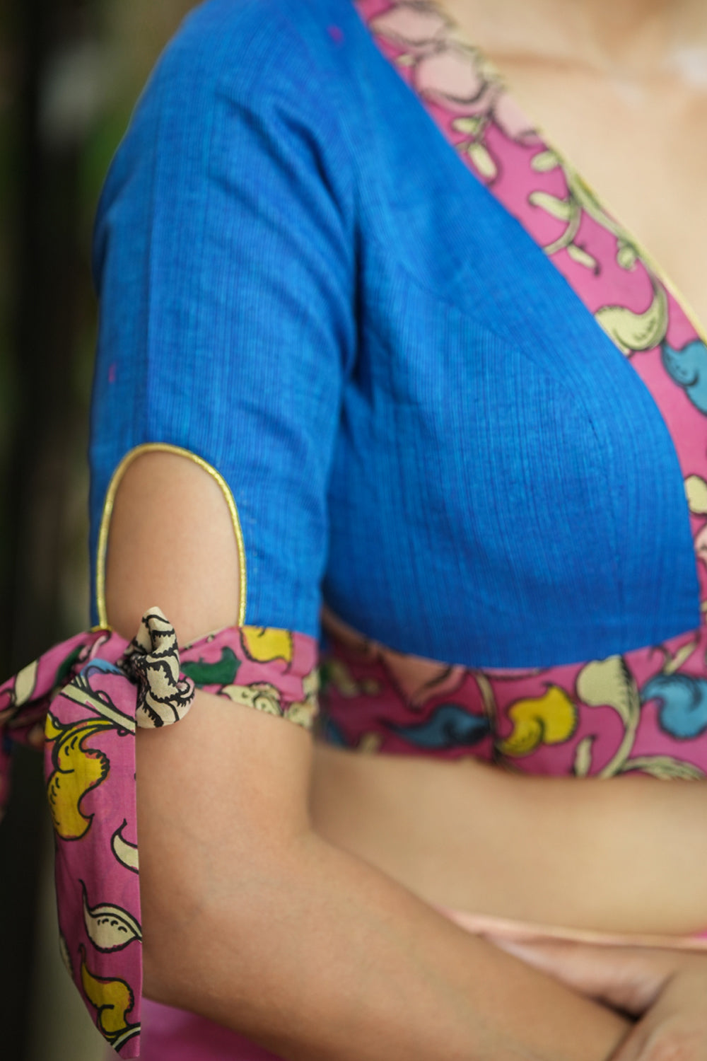 Ocean blue handloom V neck blouse with rose pink handpainted kalamkari border detailing.