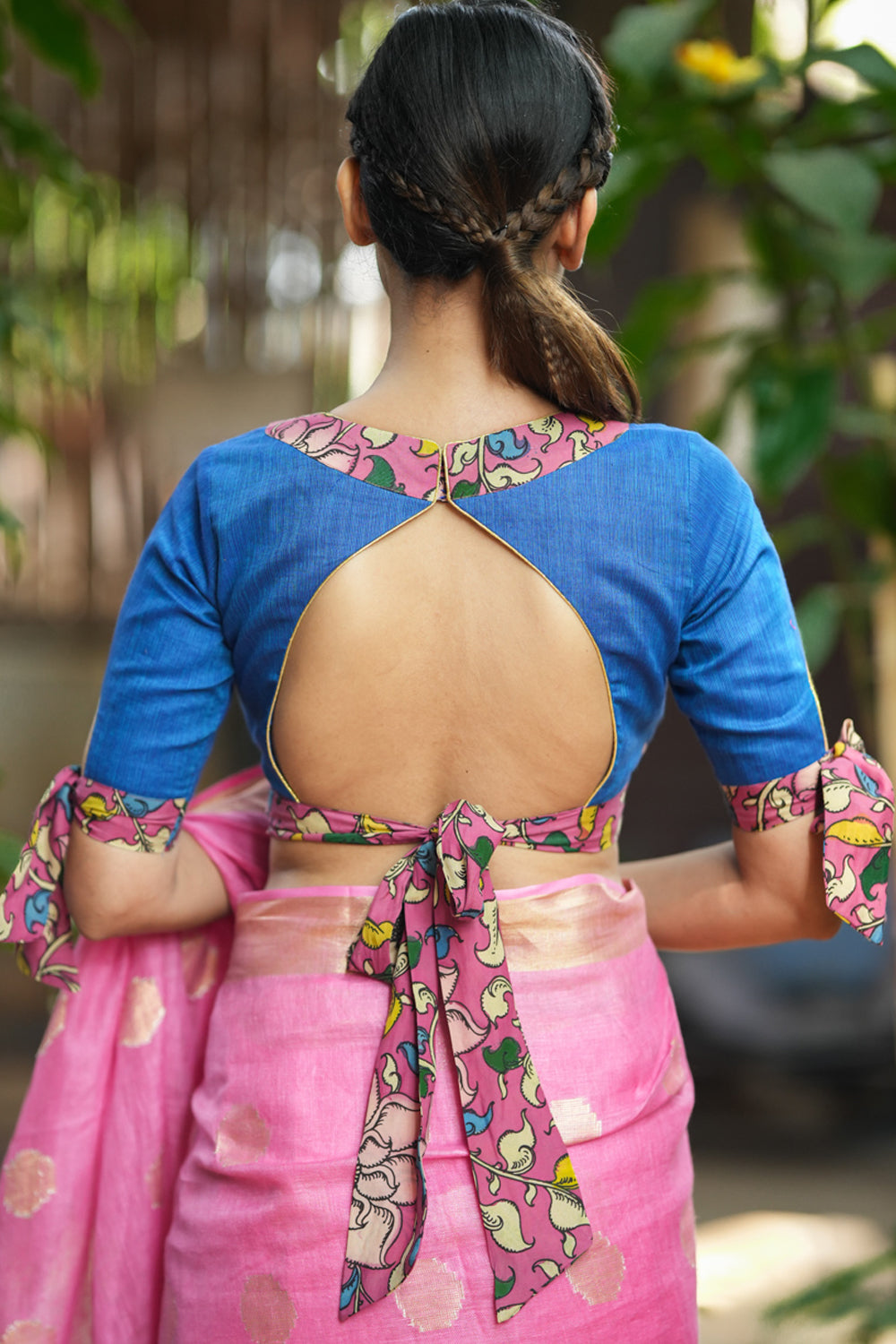 Ocean blue handloom V neck blouse with rose pink handpainted kalamkari border detailing.