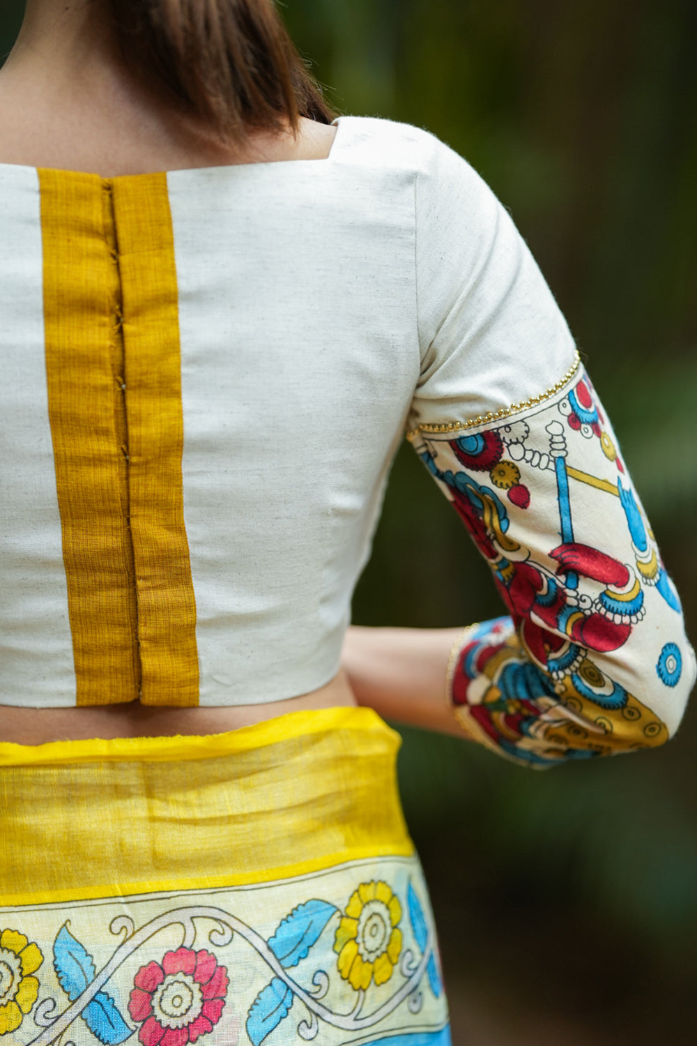 Porcelain white square neck blouse with handpainted kalamkari sleeve detailing.