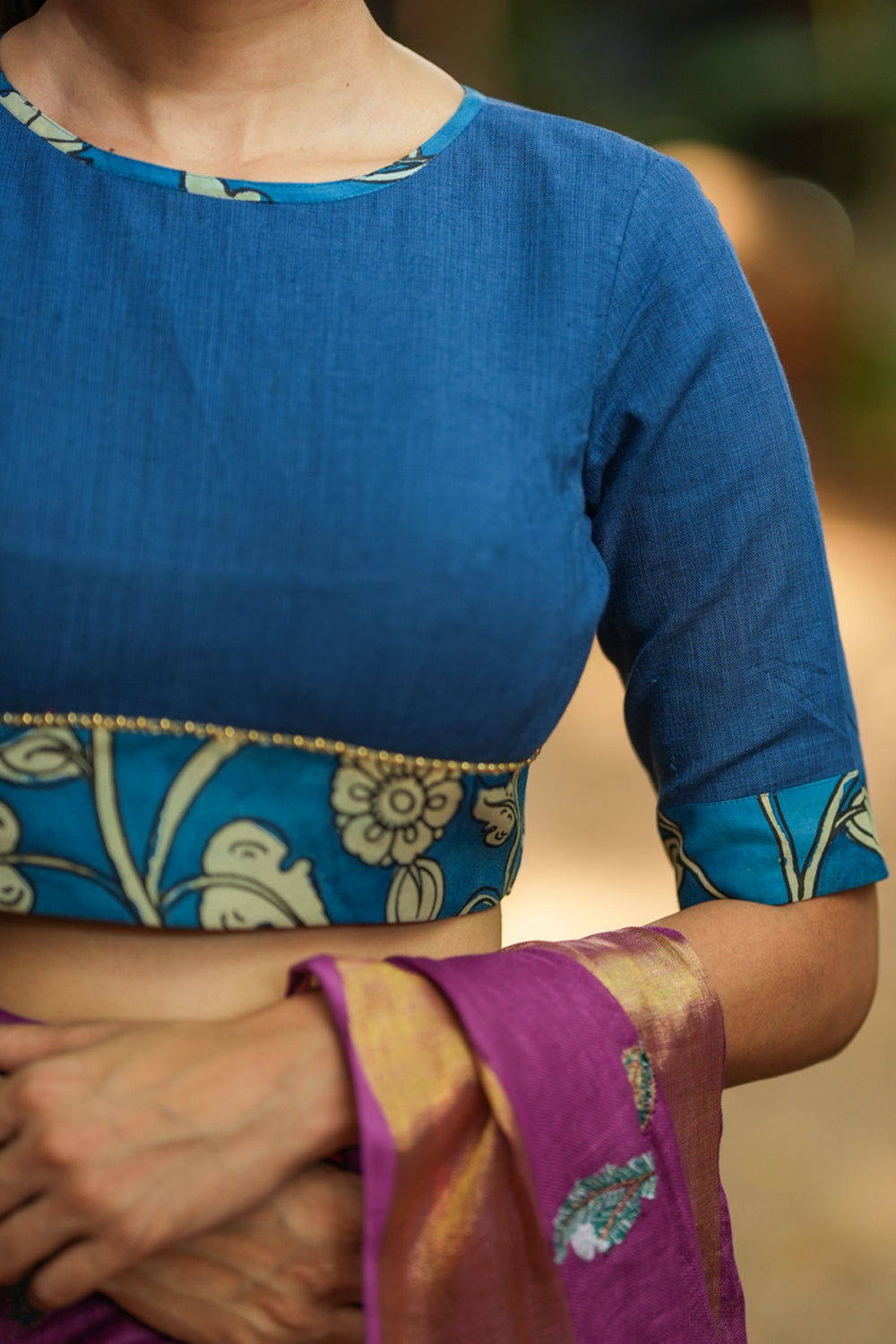 Saphire blue closed neck handloom blouse with handpainted kalamkari border.