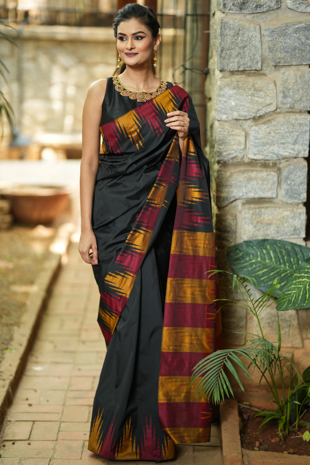 Black art silk saree with maroon and gold temple border