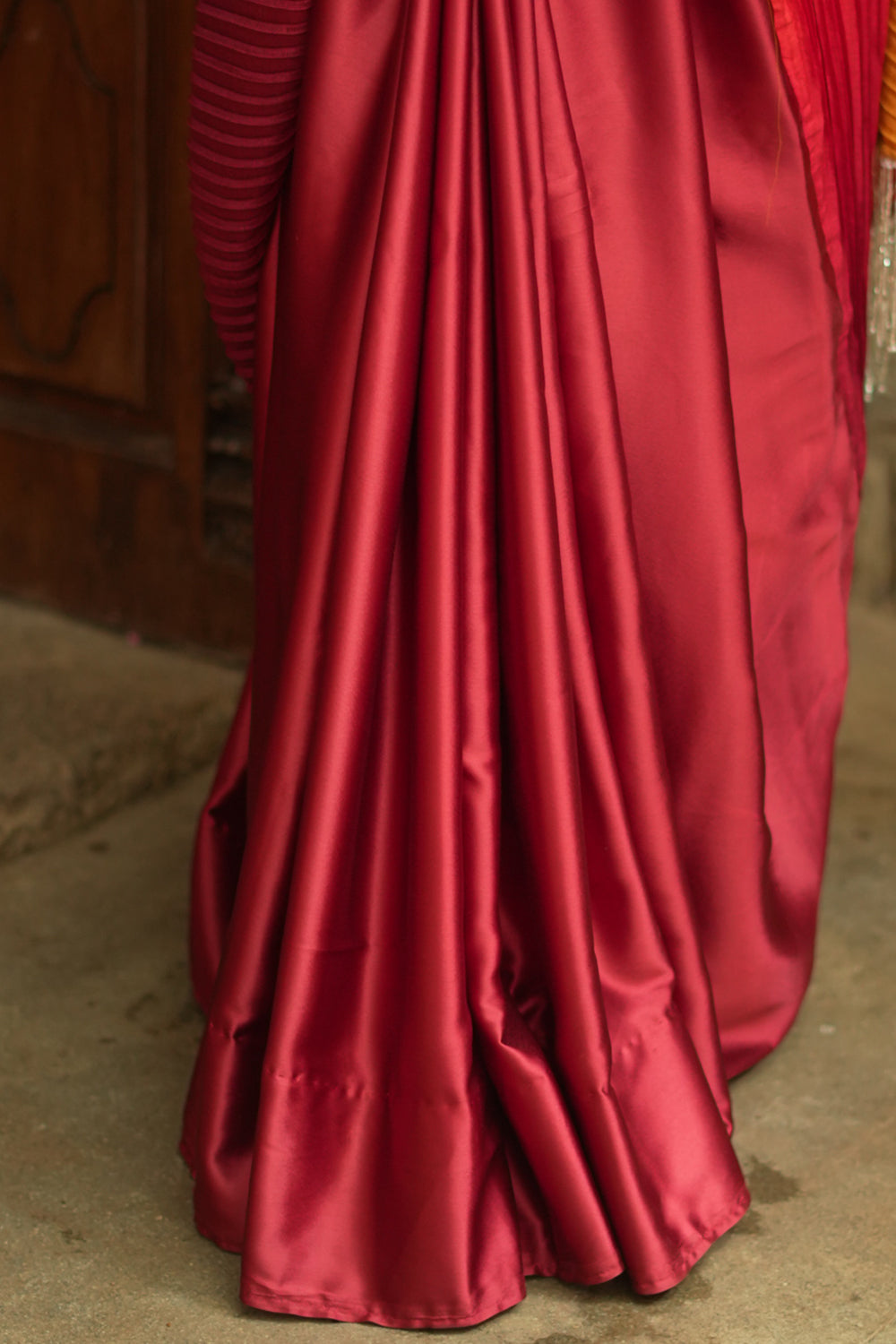 Pleated and satin half and half ombre shaded maroon and mustard saree.