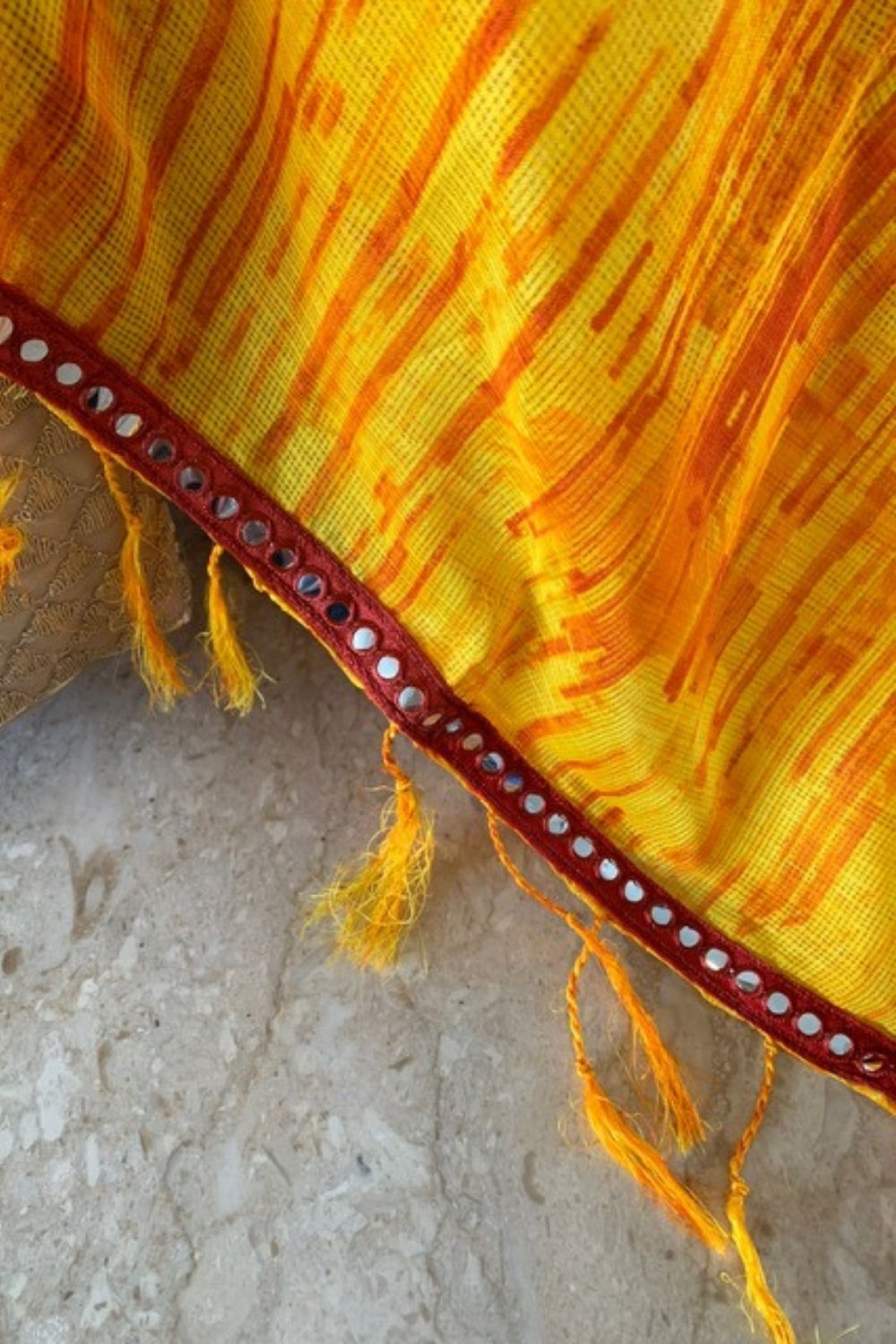Yellow and orange shibori shaded Kota dupatta with maroon mirrorwork border