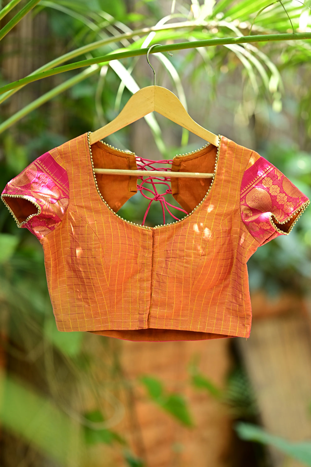 Rust orange checked U neck blouse with back detailing in Chettinad cotton