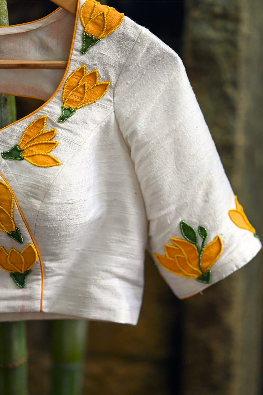 Off white raw silk U neck blouse with hand painted and embroidered sampige poovu