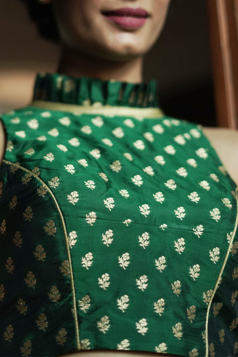 Bottle green banarasi brocade sleeveless blouse with ruffles on neck
