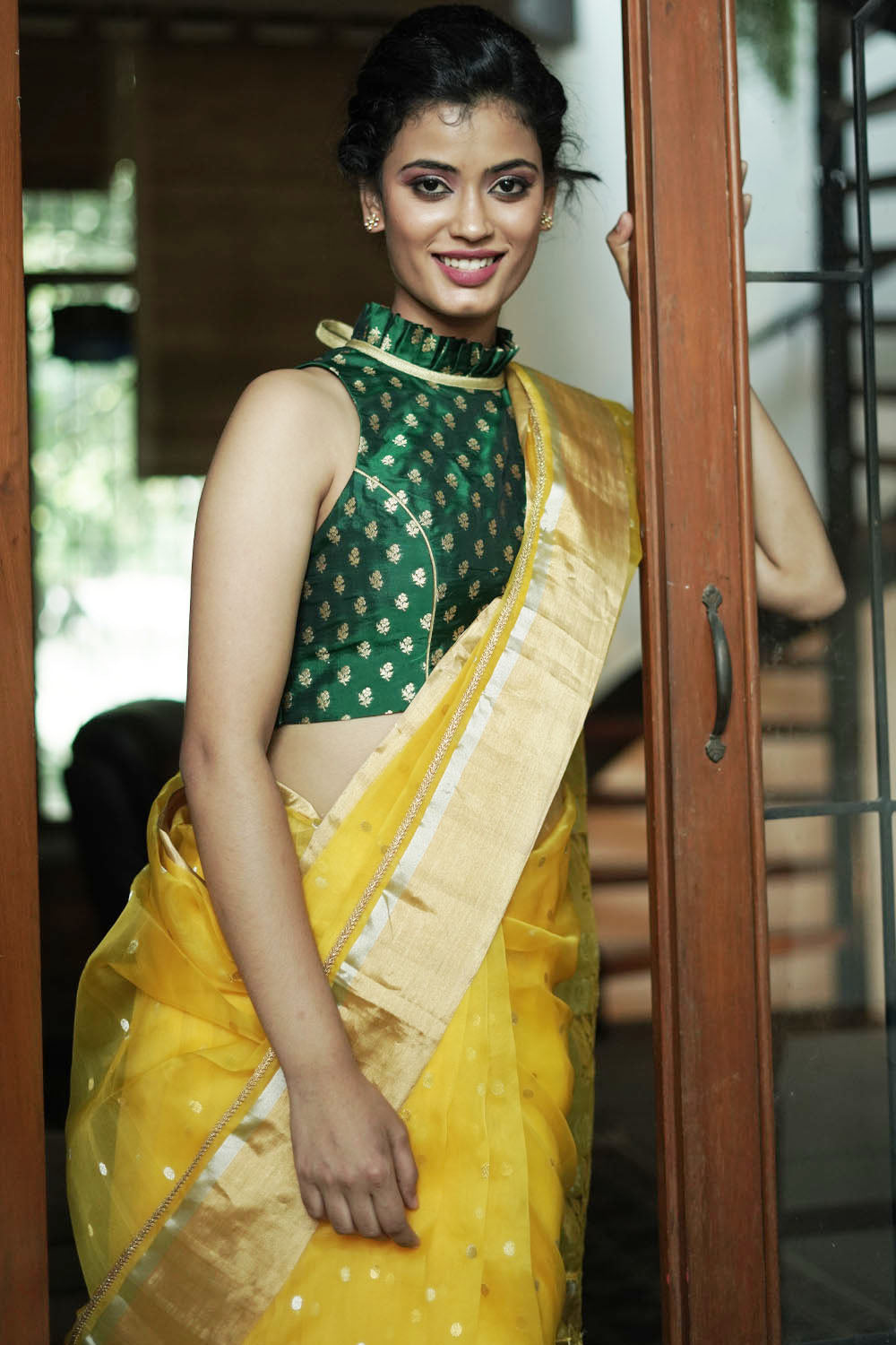Bottle green banarasi brocade sleeveless blouse with ruffles on neck