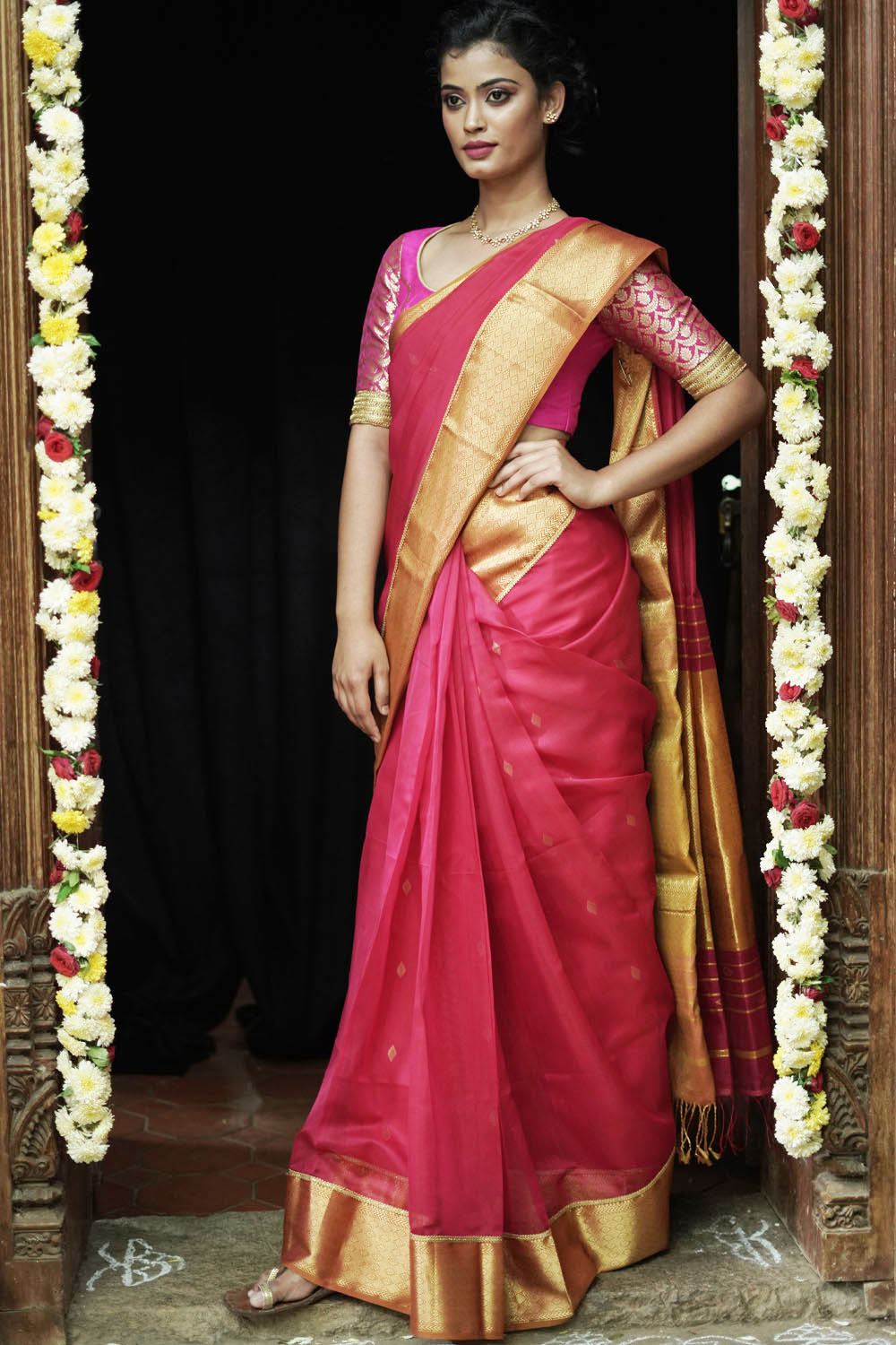 Watermelon pink maheshwari saree with gold zari border with gold lace trimming.