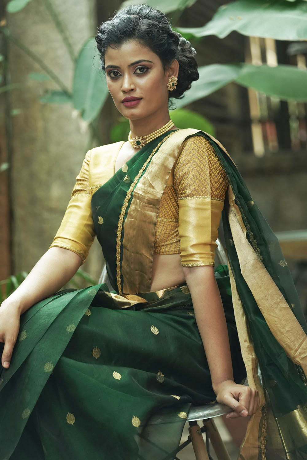 Bottle green chanderi saree with gold zari buttis and gold tissue border with gold lace.