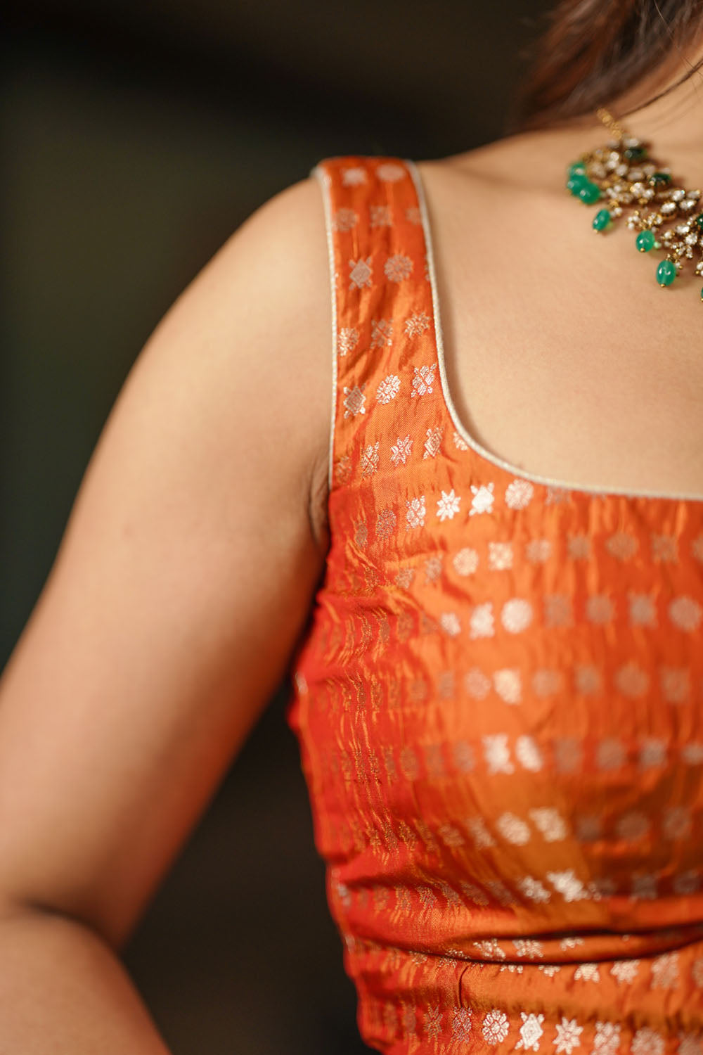 Orange rounded square neck brocade silk sleeveless  blouse.