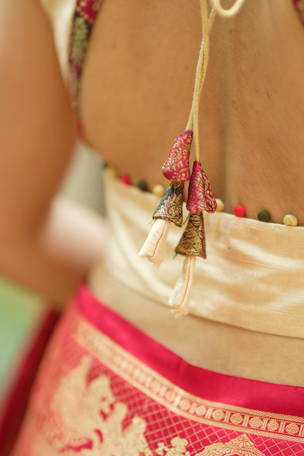 Ivory pure raw silk V neck sleeveless blouse with banarasi trim and potli button detailing