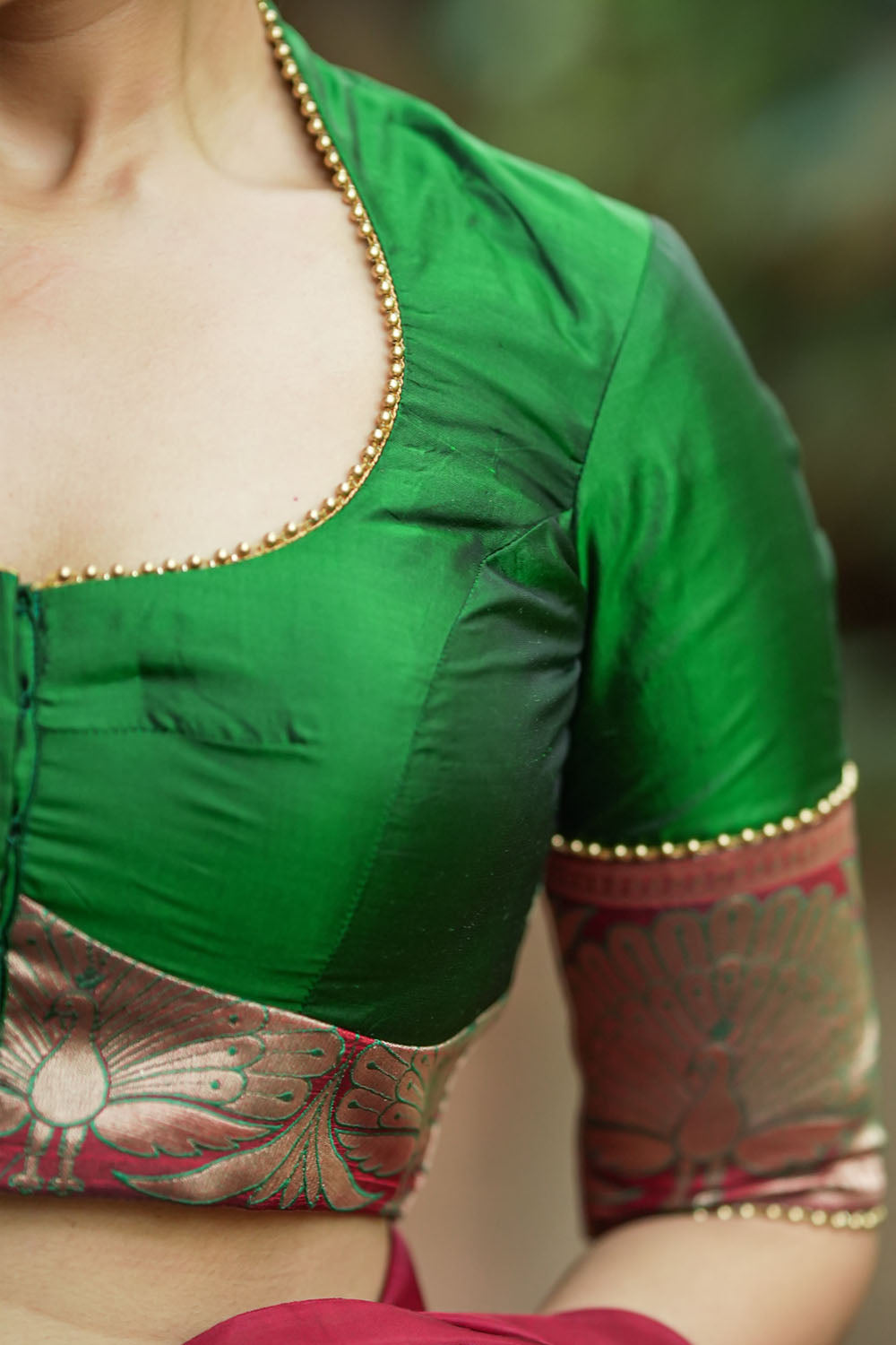 Emerald green silk pot neck blouse with peacock brocade border