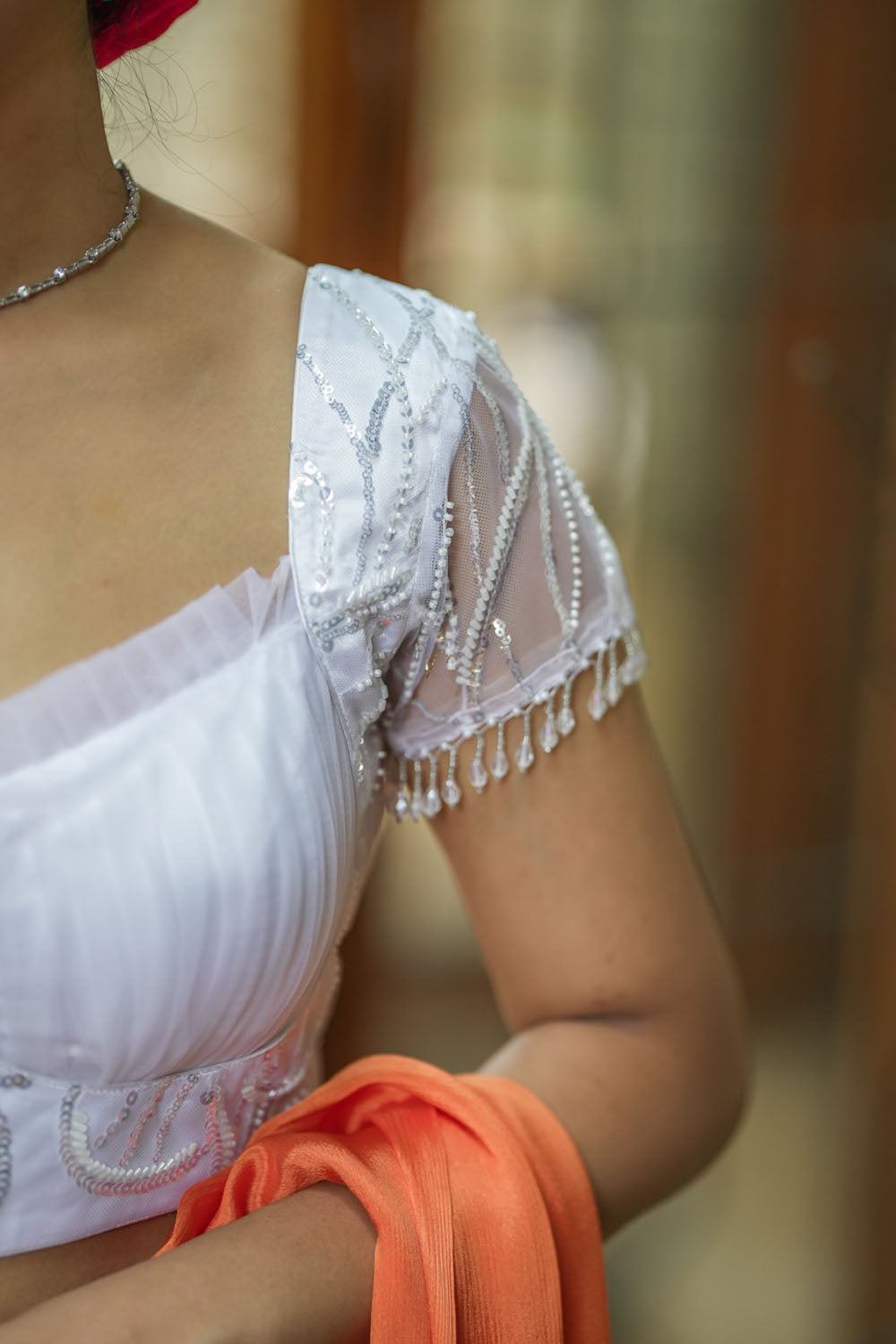 White sequin sweetheart neck blouse with  net frills detailing.