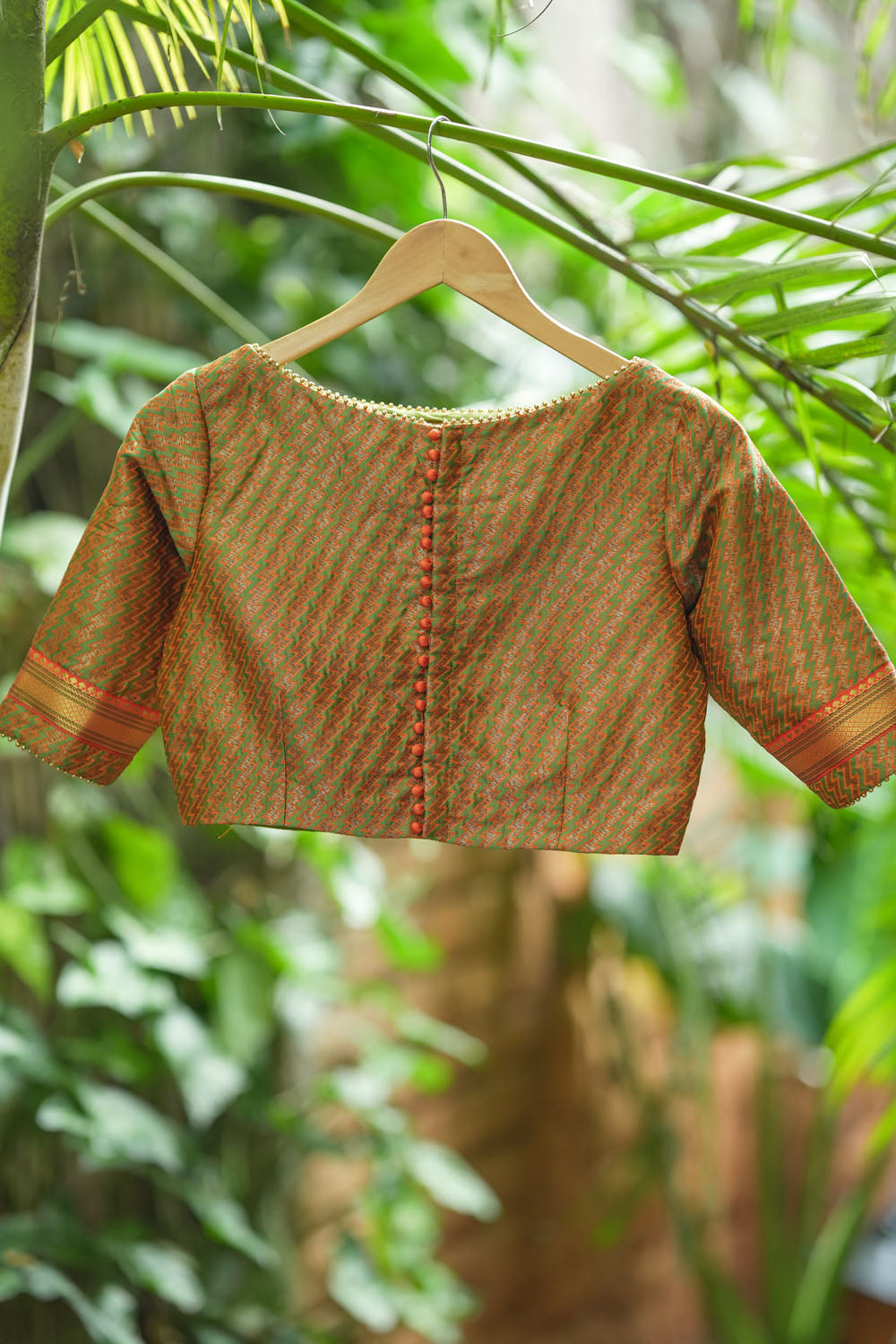Green jacquard orange brocade boatneck blouse with plain silk detailing