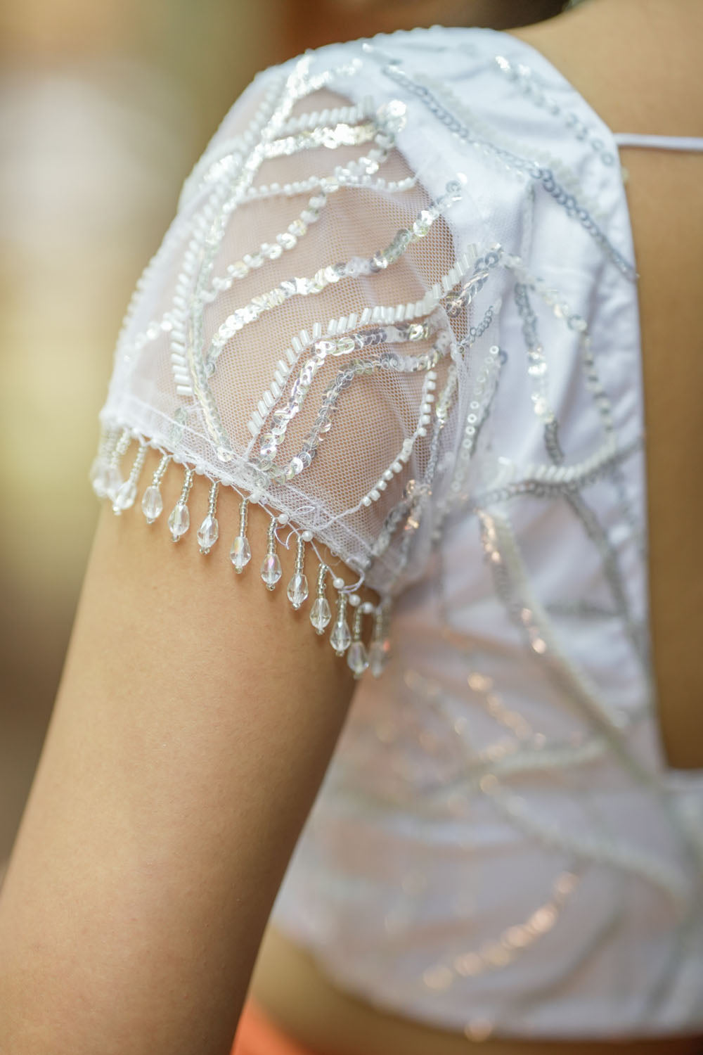 White sequin sweetheart neck blouse with  net frills detailing.