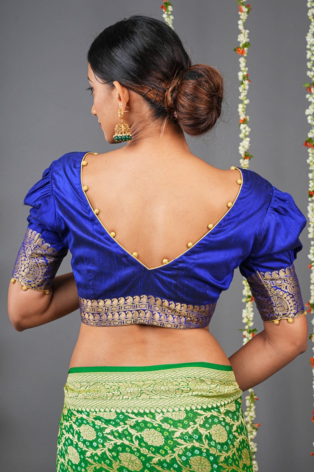 Blue silk V neck blouse with  potli buttons detailing and brocade border.
