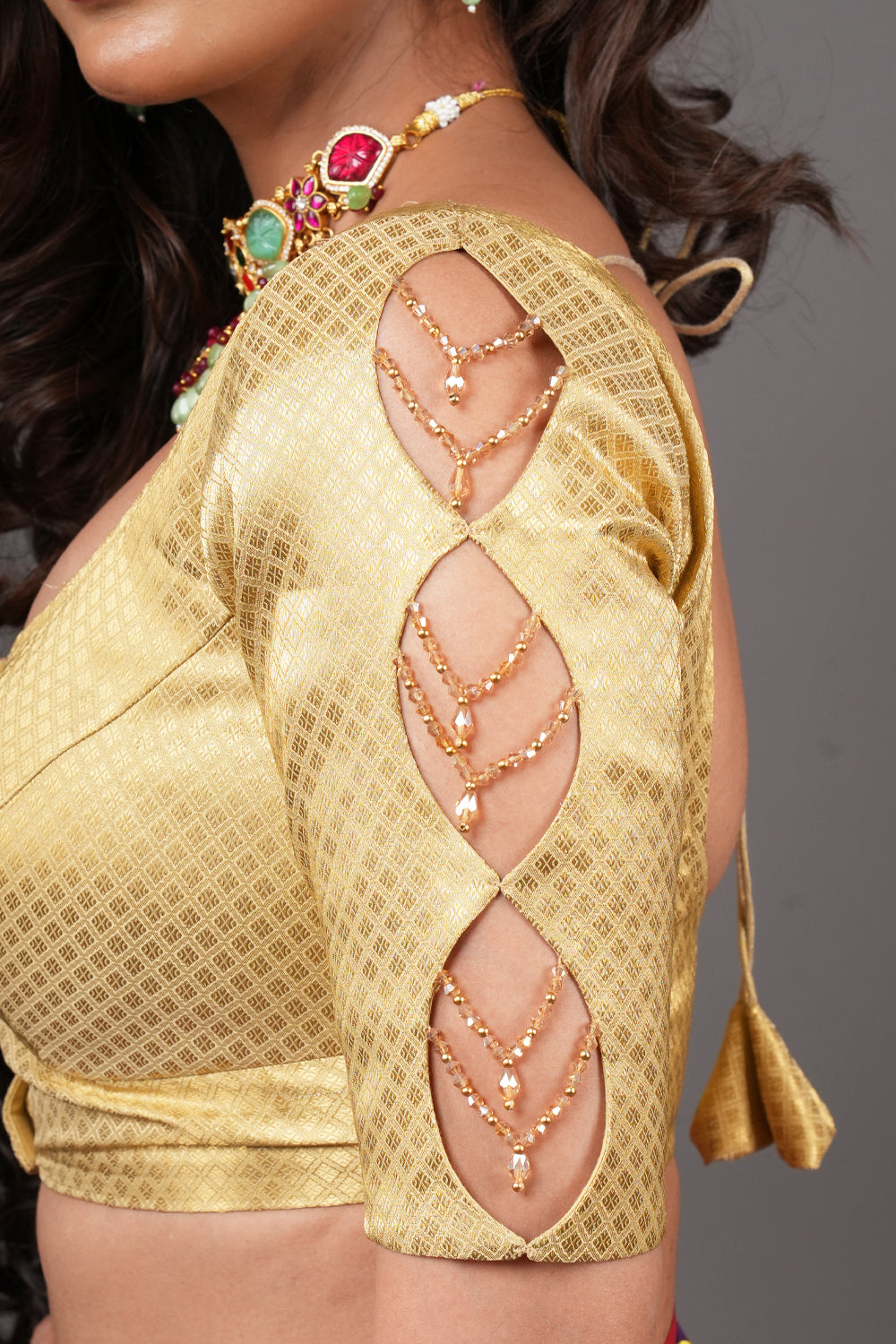 Gold brocade U neck  blouse with cutout  and crystal detailing in sleeves.