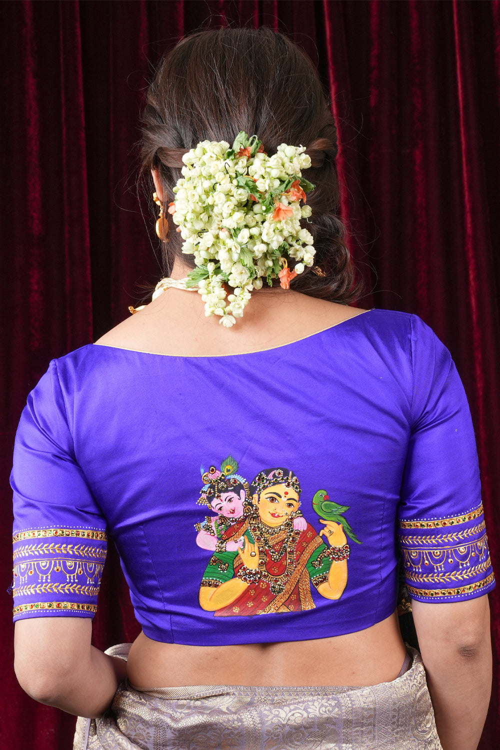Purple pure silk sweetheart neck blouse with handpainted and hand embroidered baby Krishna and Yashodha and detailing on sleeves.