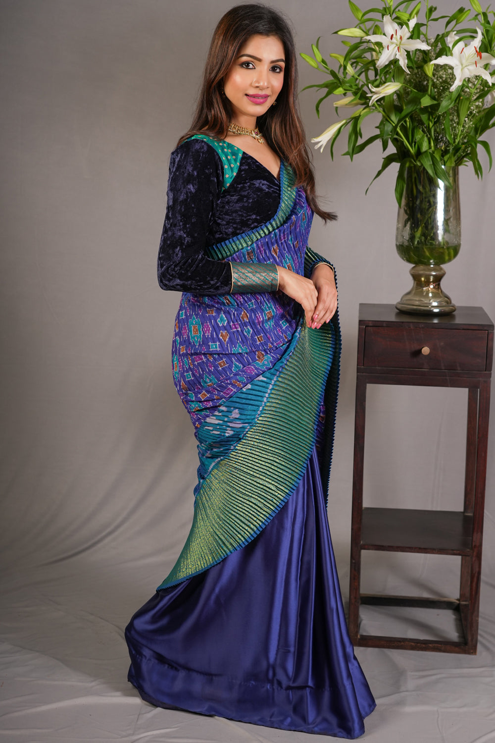 Royal blue and green pleated half and half satin saree with patola digital print.