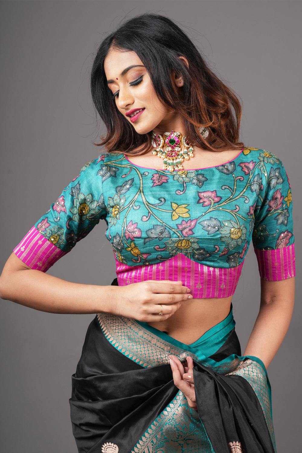 Teal pure tussar silk boatneck blouse with kalamkari print and sequins and pink brocade border.