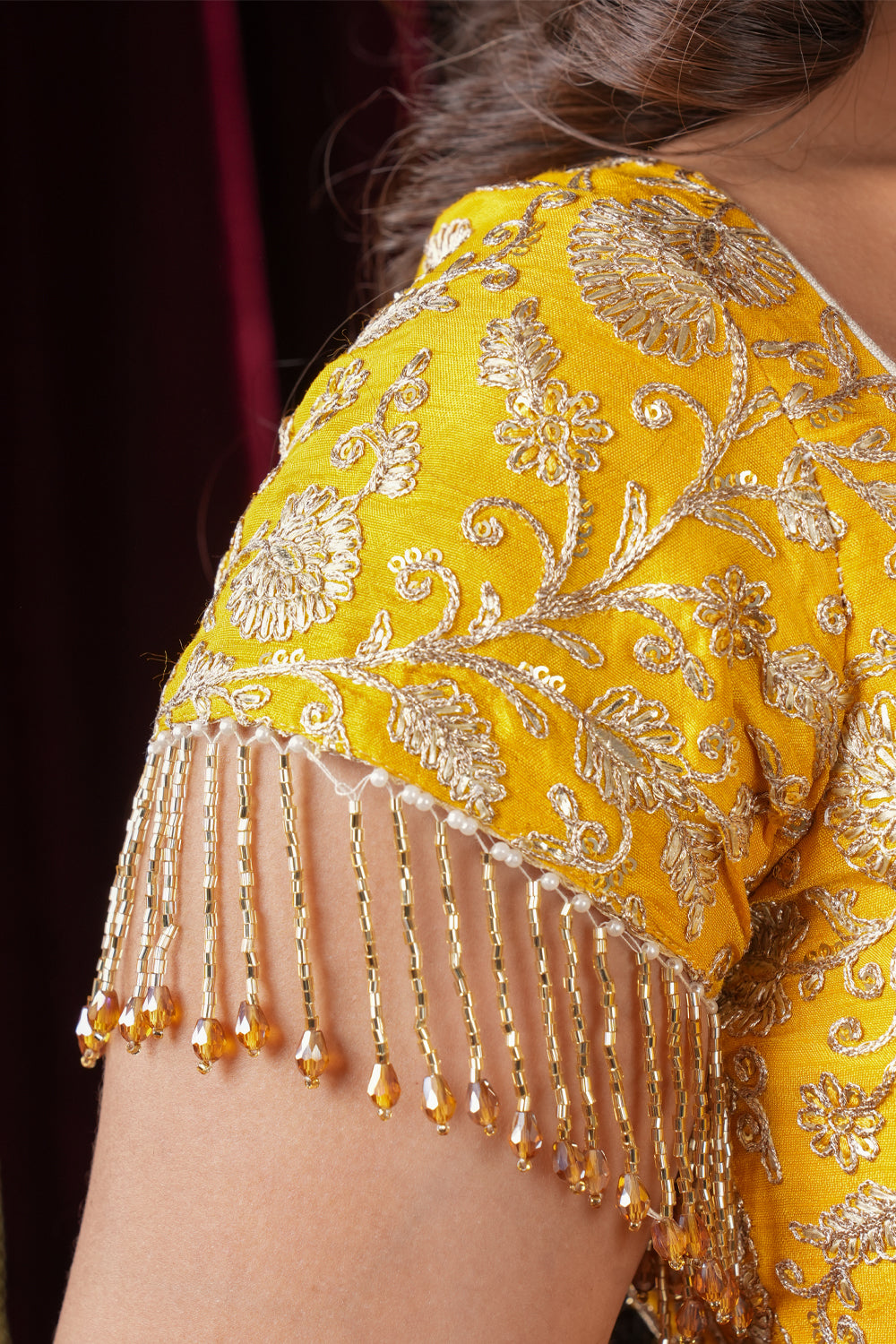 Yellow  embroidered rounded V neck blouse with dangling beads on sleeves and mandala detailing.