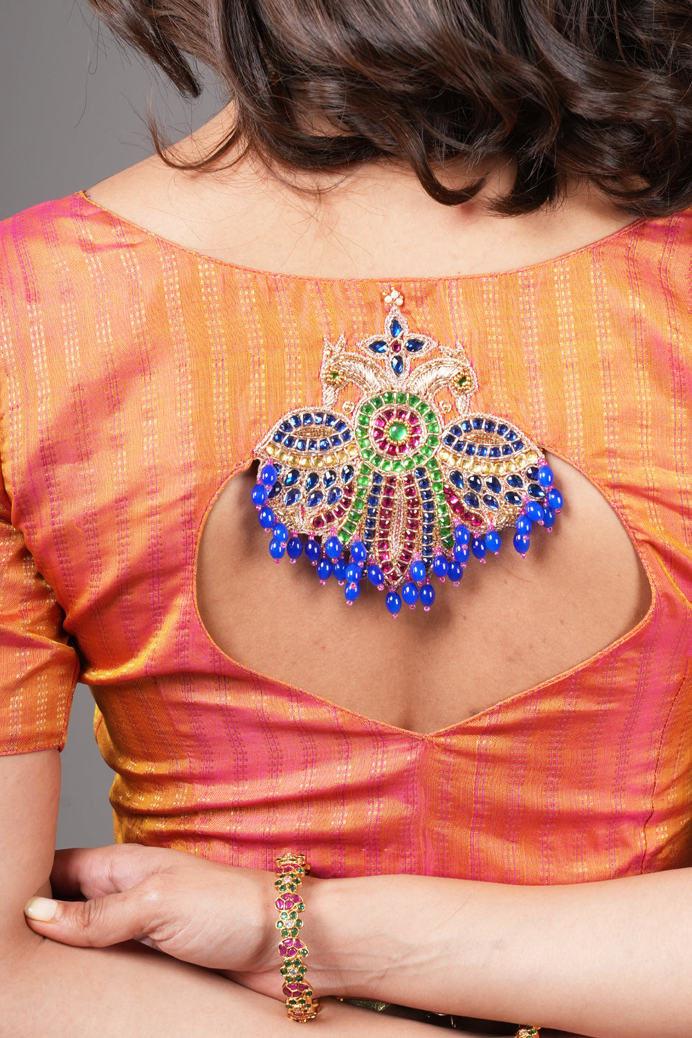 Kesari pure kanjivaram silk close neck blouse with handworked motifs on back and sleeves.