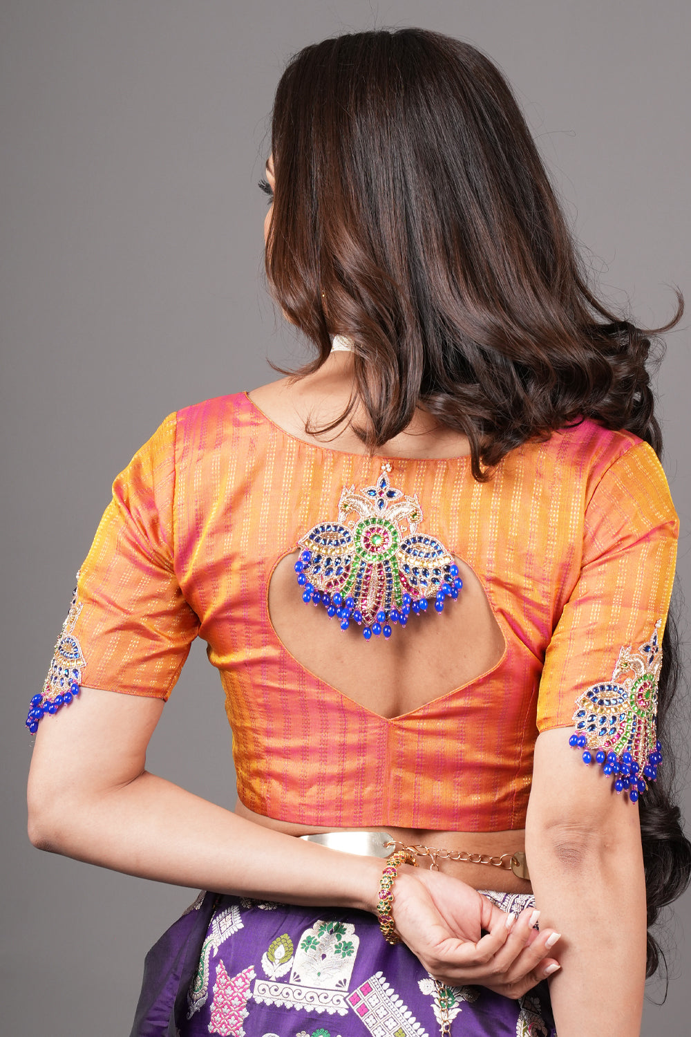 Kesari pure kanjivaram silk close neck blouse with handworked motifs on back and sleeves.