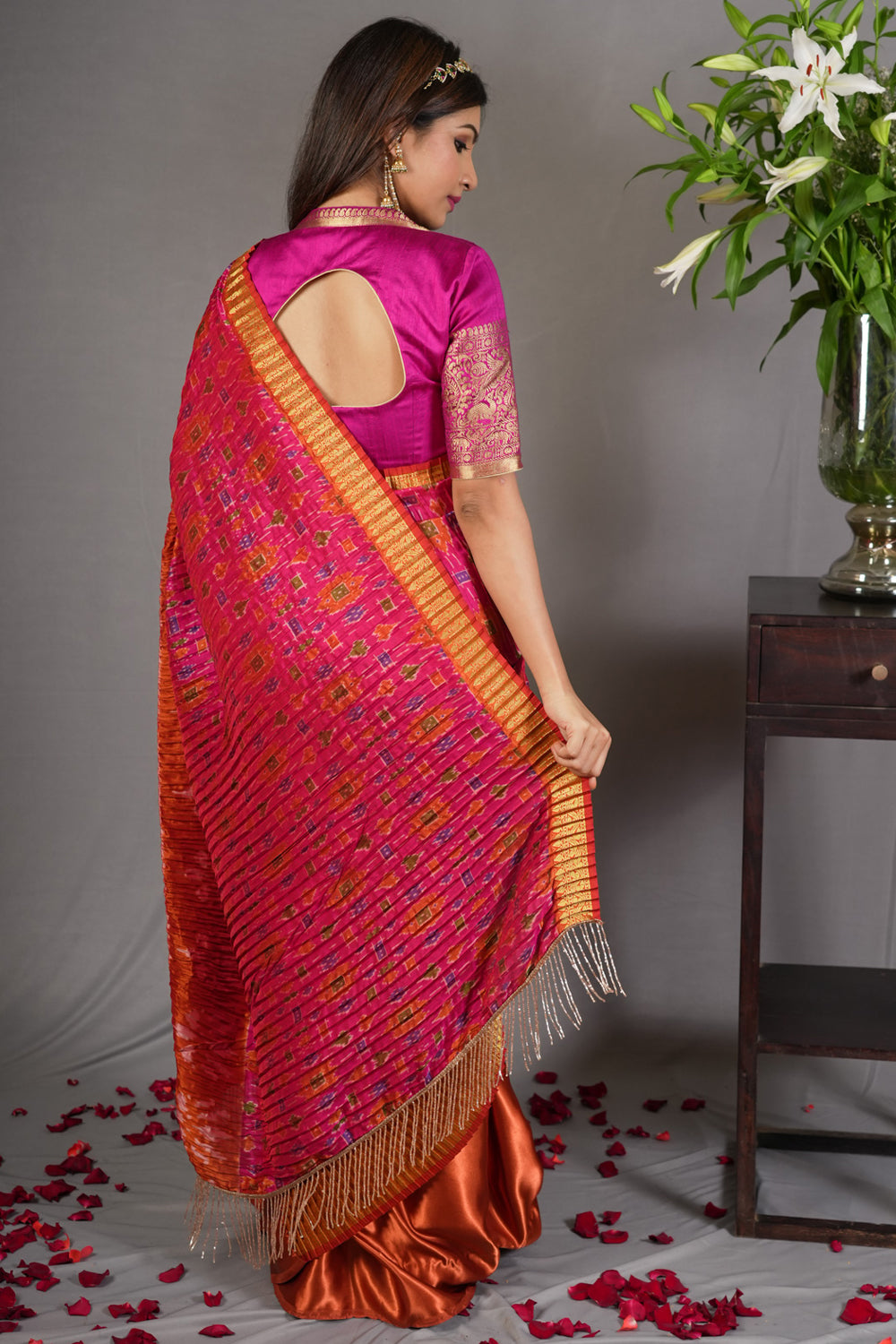 Pink and rust pleated half and half satin saree with patola digital print.