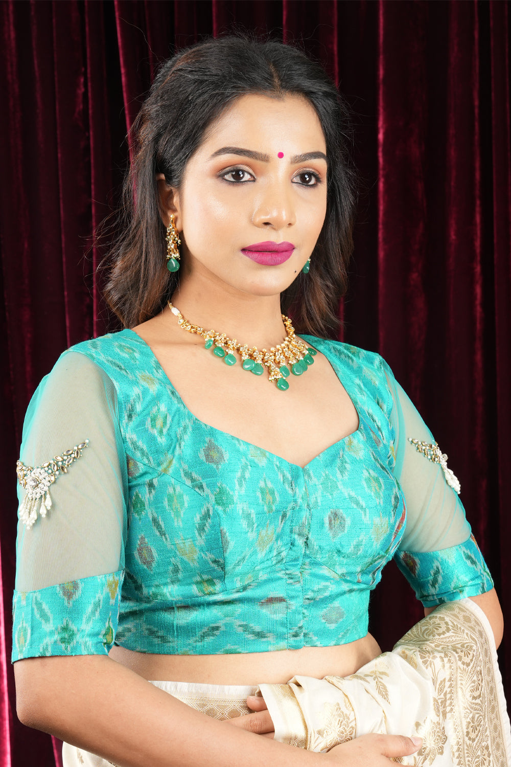 Elegant Teal Ikkat Blouse with Handcrafted Detailing and Sheer Net Sleeves